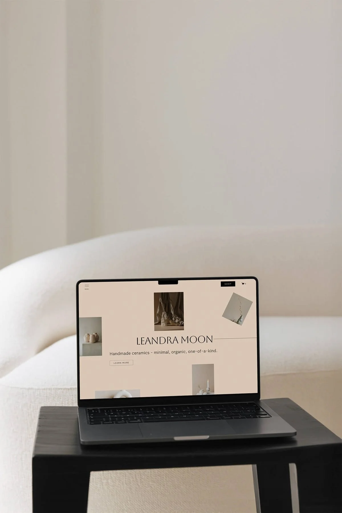 Laptop displaying the Leandra Moon handmade ceramics website homepage with product photography