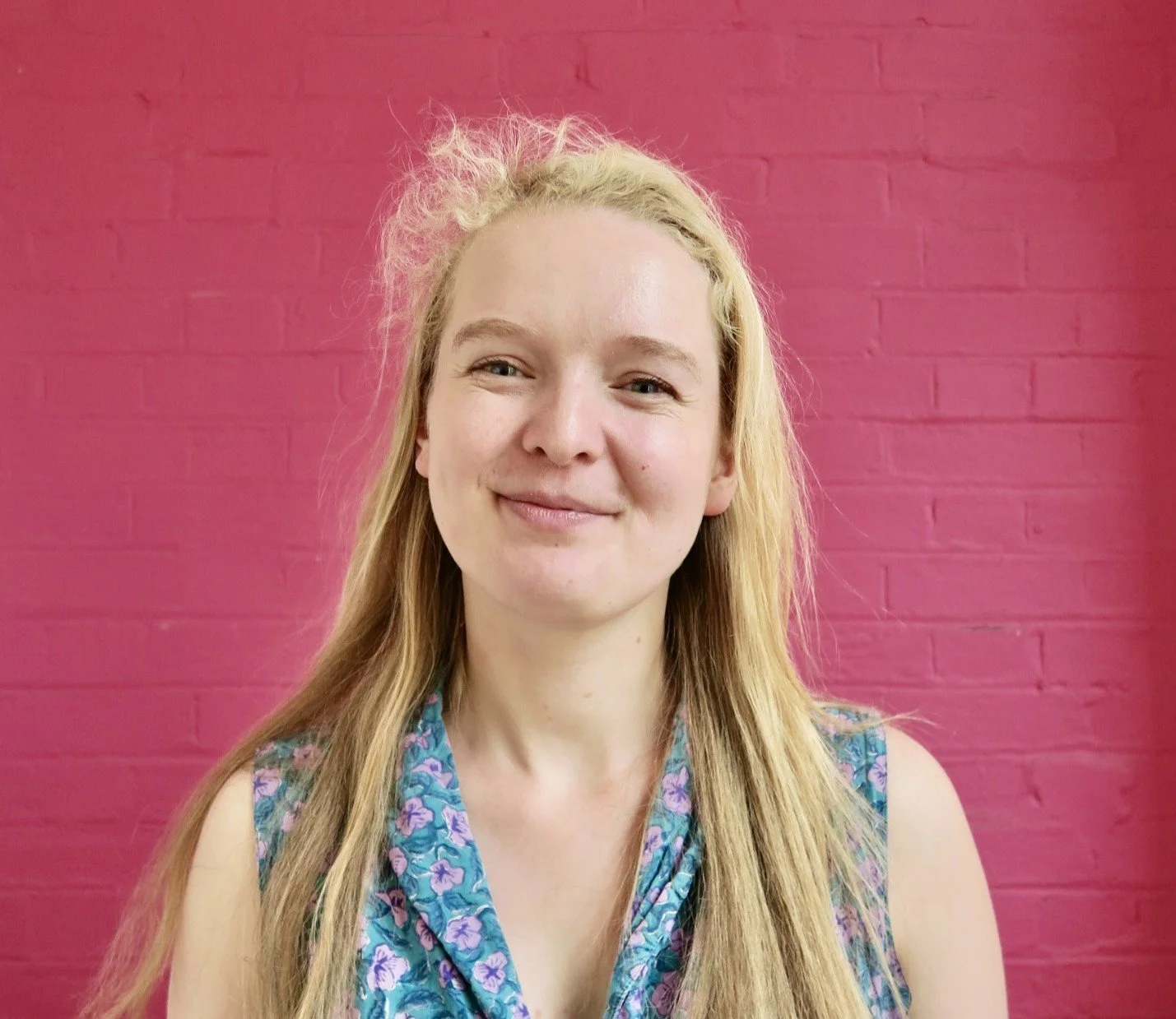 Picture of Sarah, one of the staff members, smiling at the camera