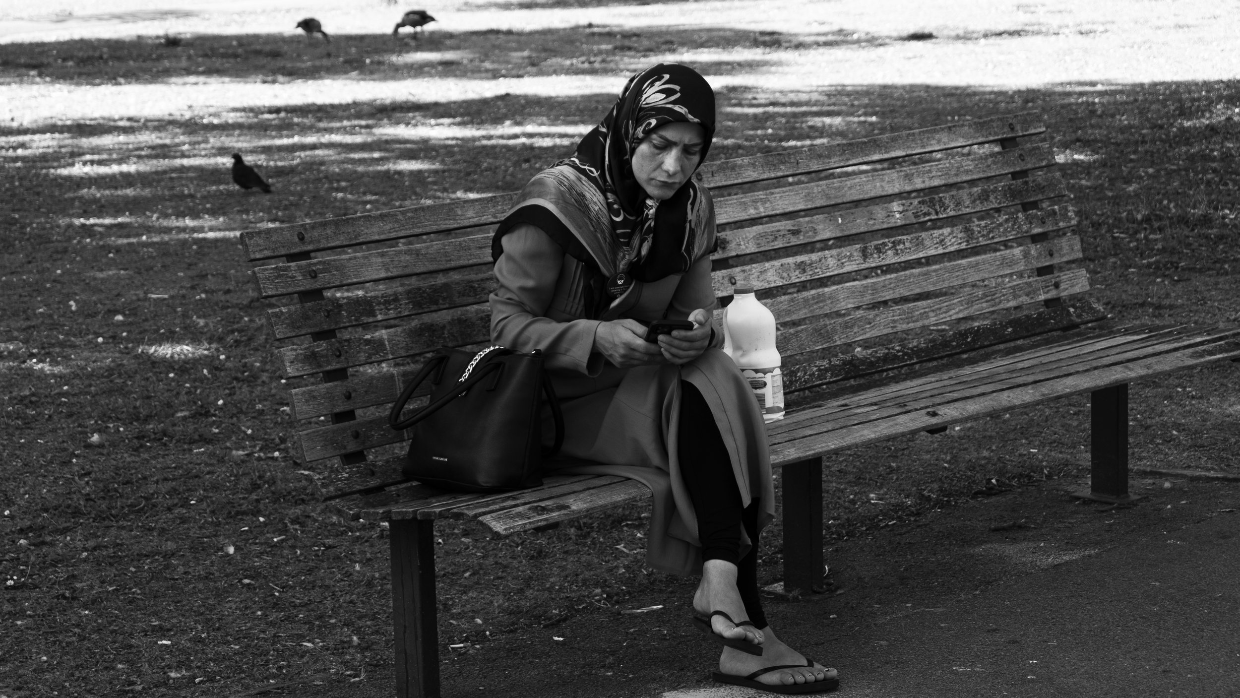 Muslim Woman with Phone on Bench Regents Park - 08.09.21.jpg