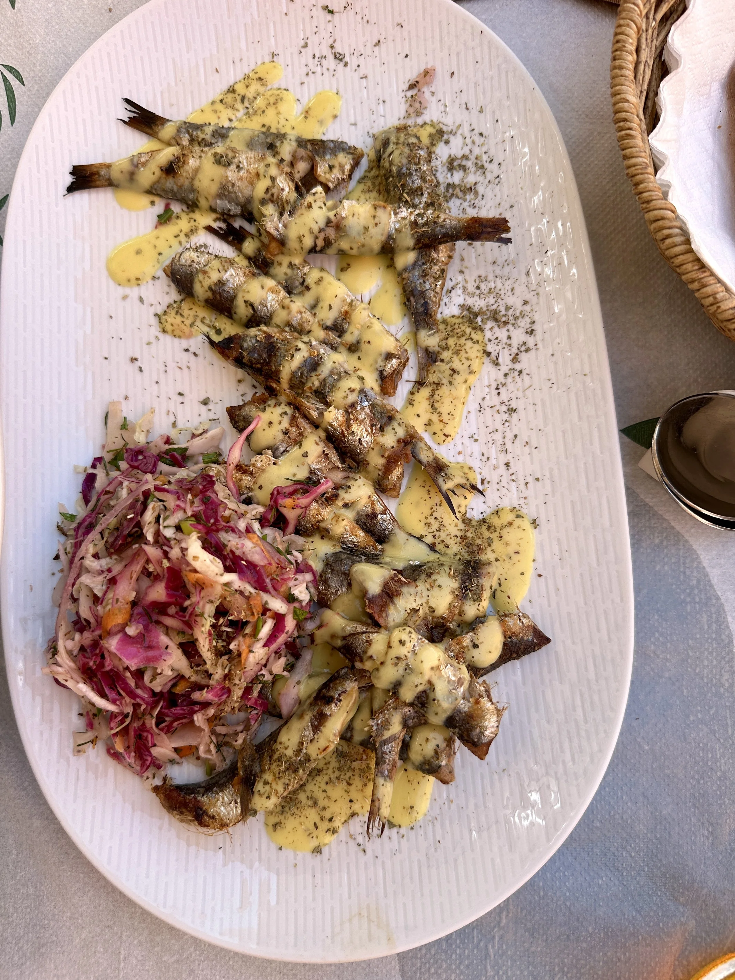 with grilled sardines and salad.