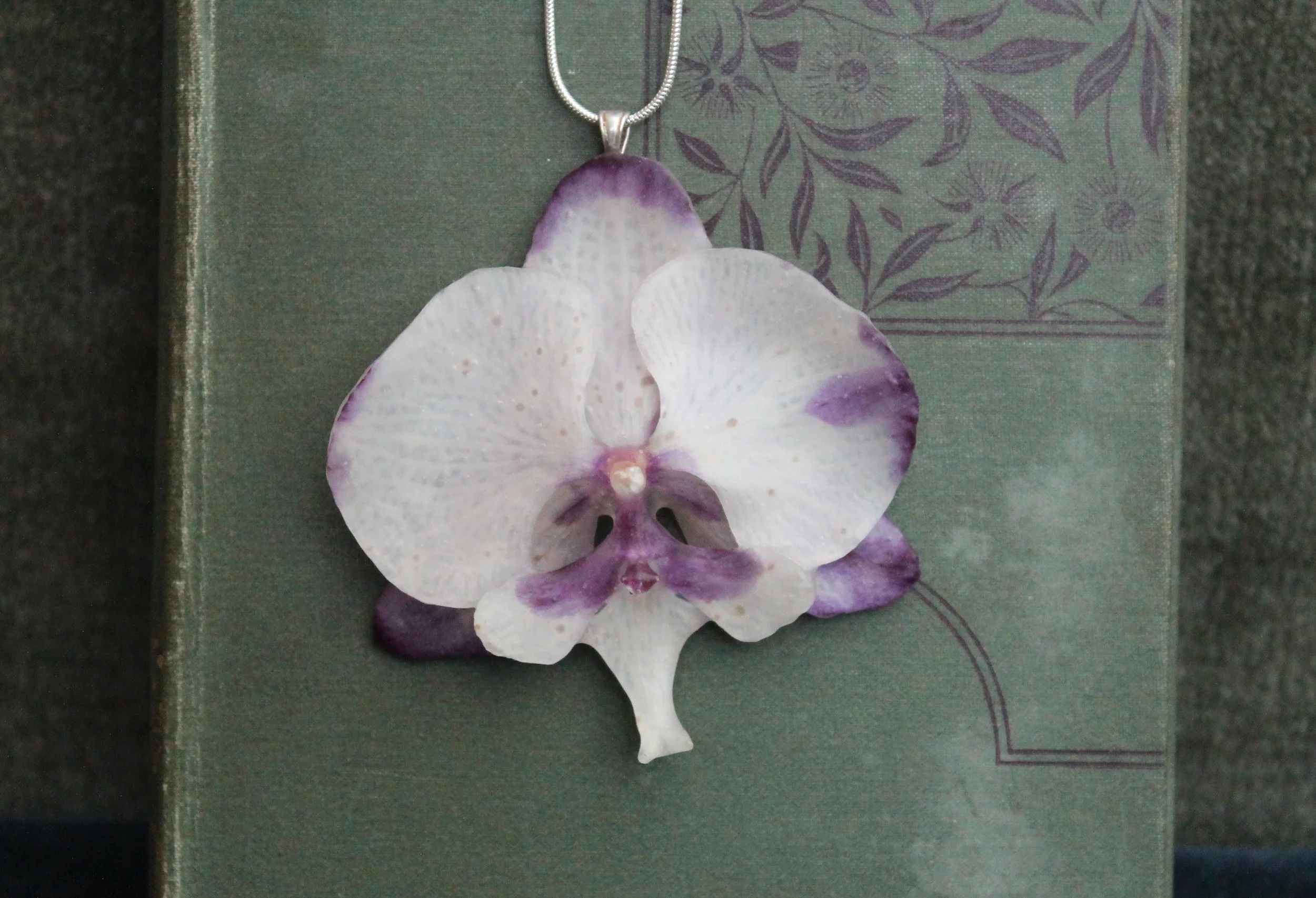 White and Pink Orchid on Book 1.jpg