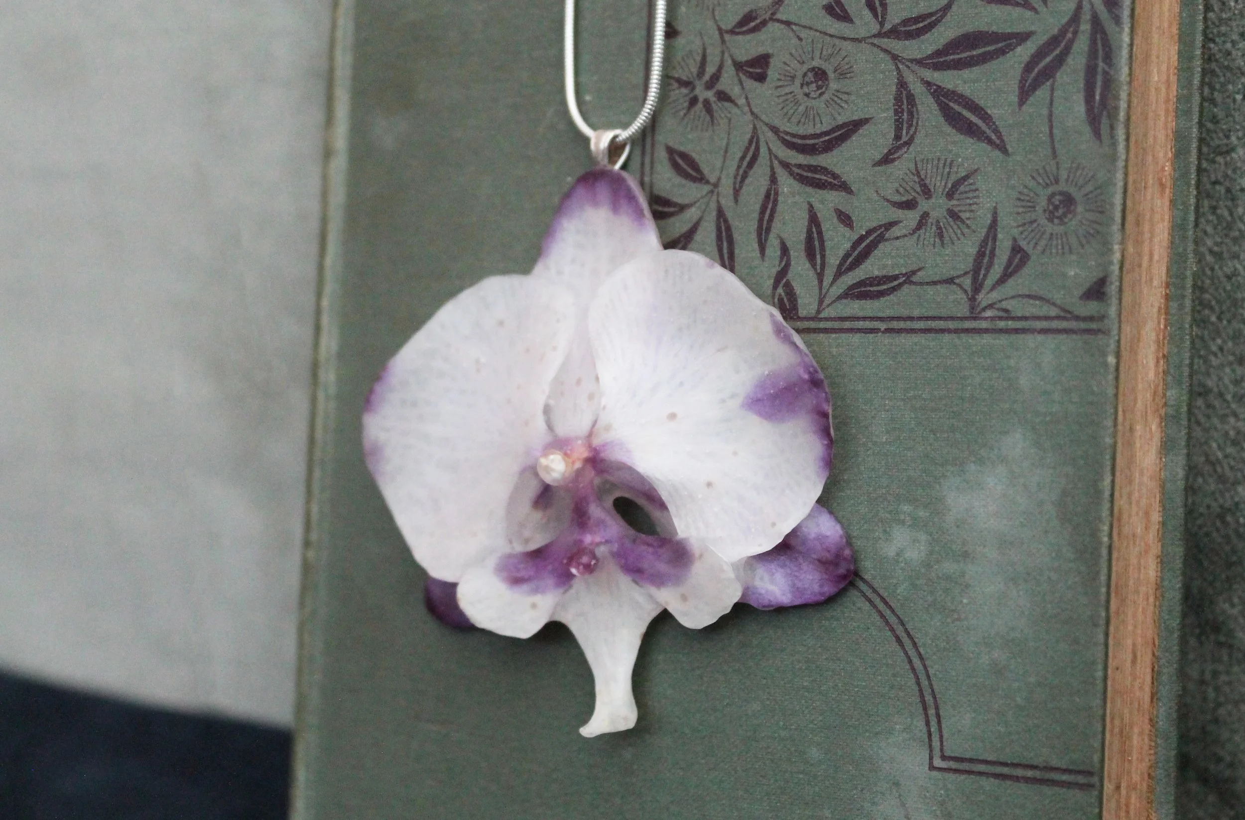 White and Pink Orchid on Book 2.jpg
