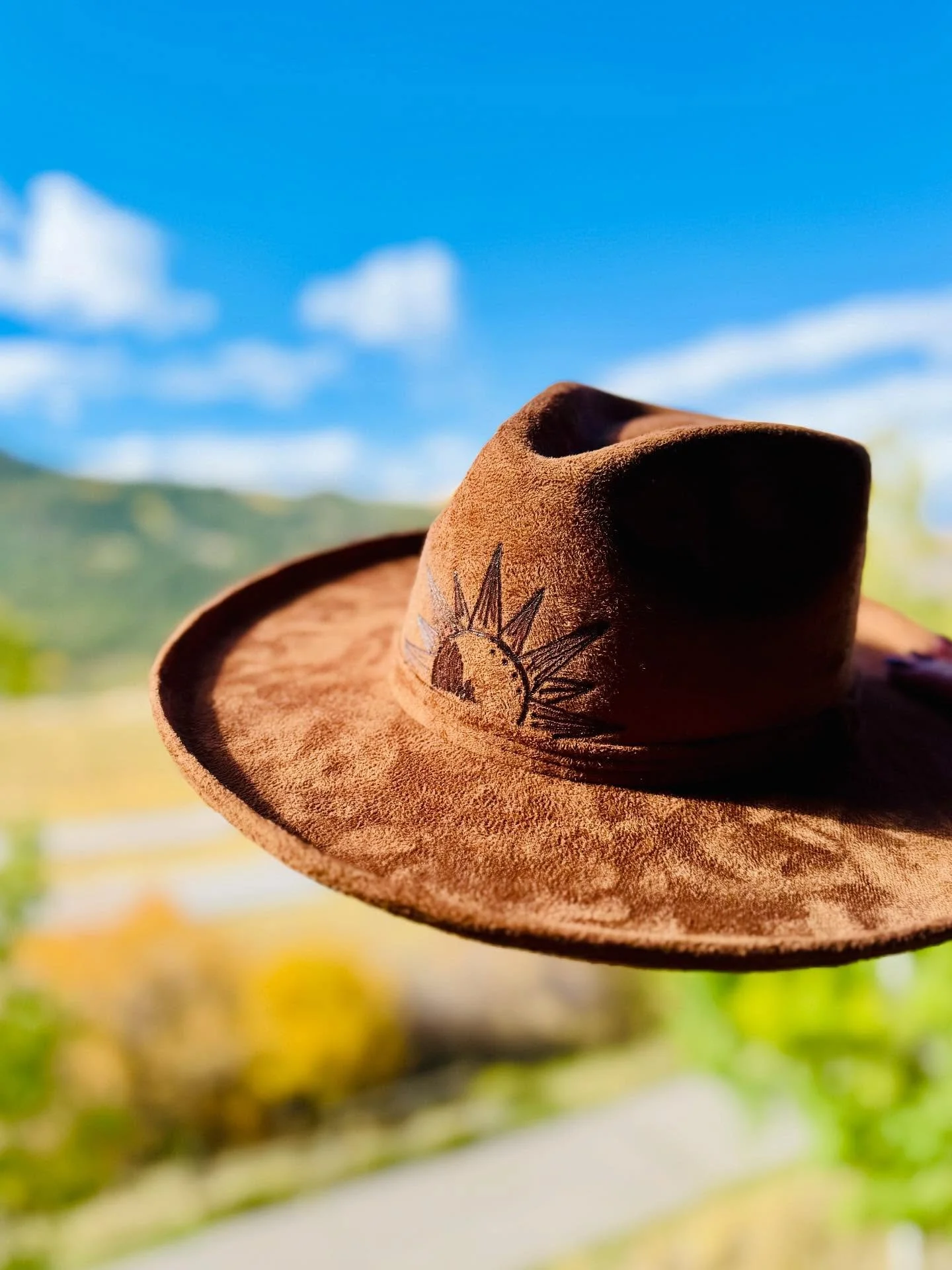 &mdash;&mdash;&mdash;
D E S E R T  D A Z E ☀️
&mdash;&mdash;&mdash;
This one brings the heat&mdash;featuring a hand-burned snake + cactus design under the brim and a sunshine-detailed hat band on top. Built on a stiff brown faux suede rancher with a 