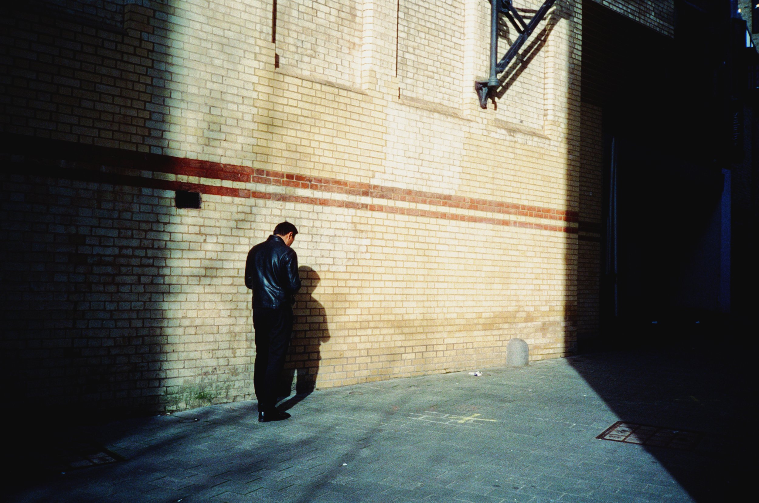 Man smoking cigarette in an alley — London, UK