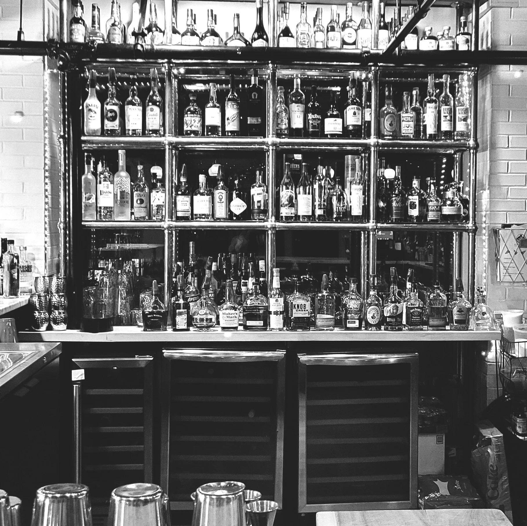 Black and white bar scene with neon lettering