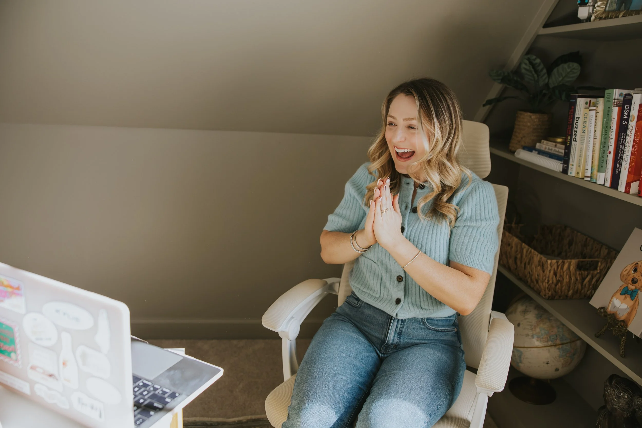 Woman smiling with hands clasped, feeling settled and secure