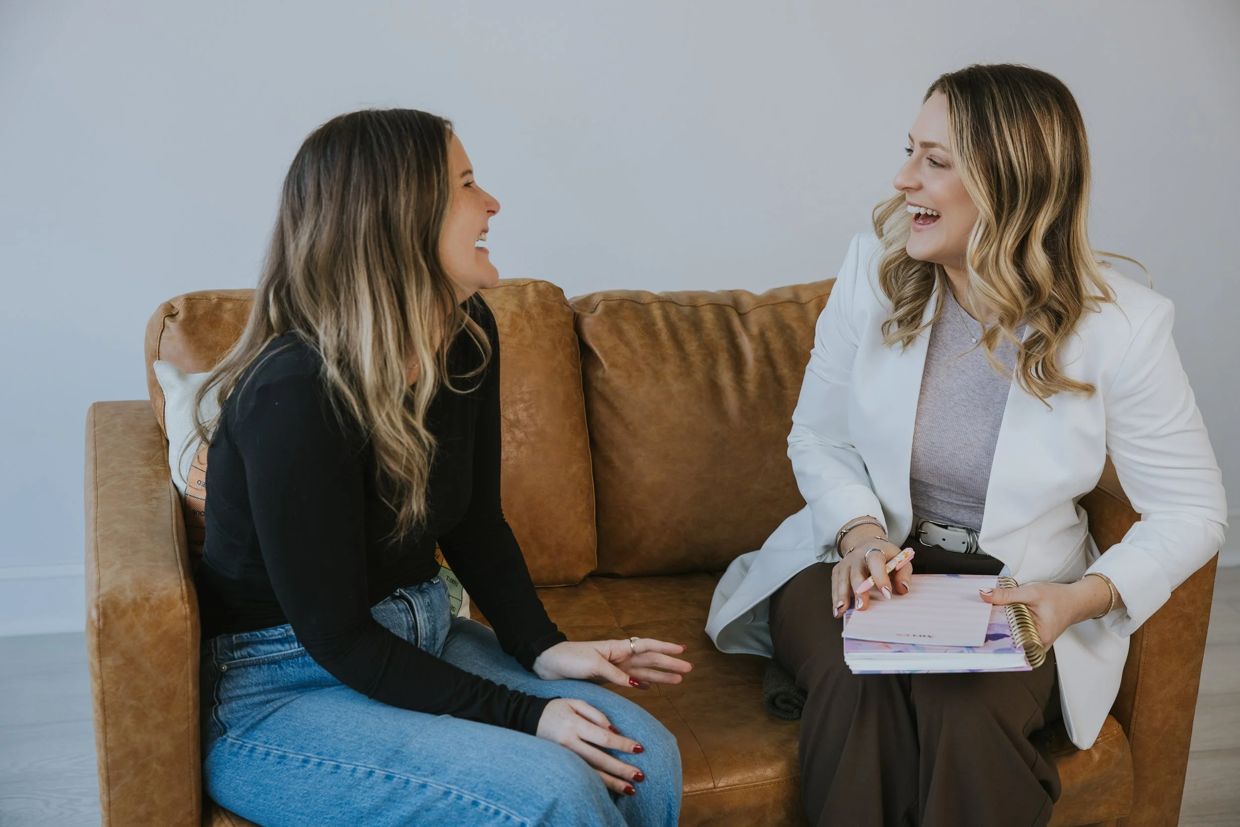 Kylie Lambert laughing with a client during a therapy conversation