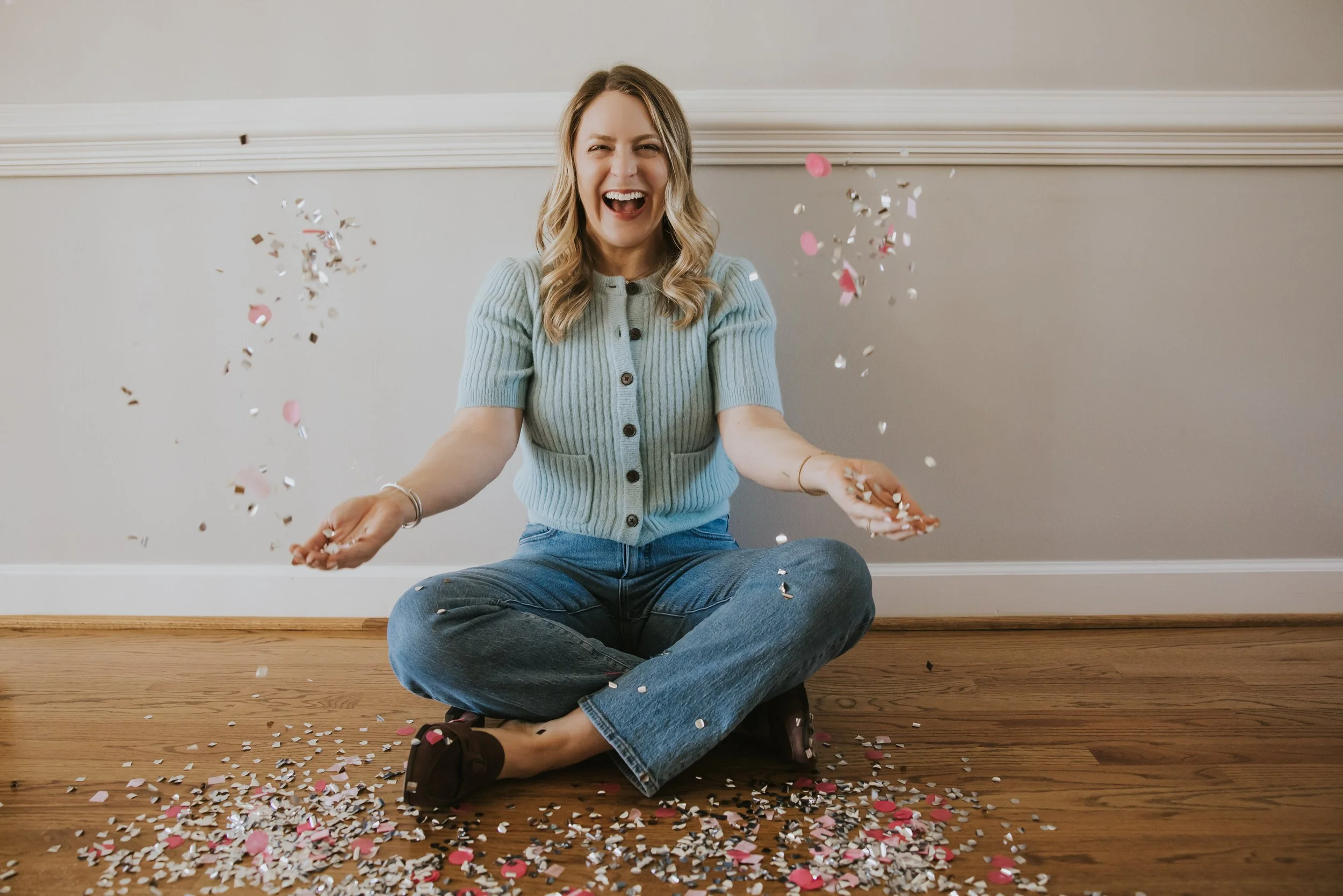 Woman celebrating with confetti, representing freedom from self-criticism