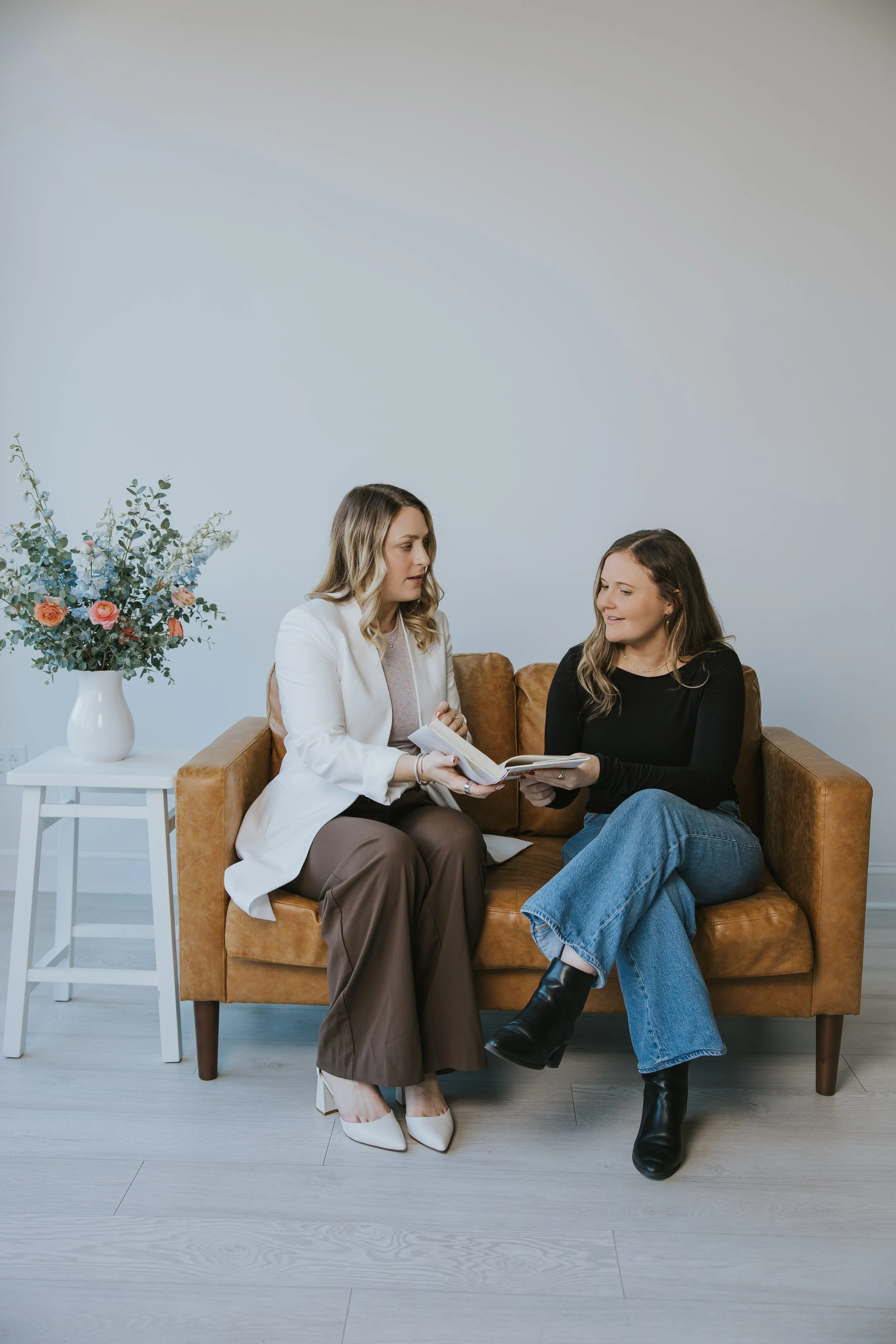 Kylie Lambert talking with a client during a therapy session on a couch
