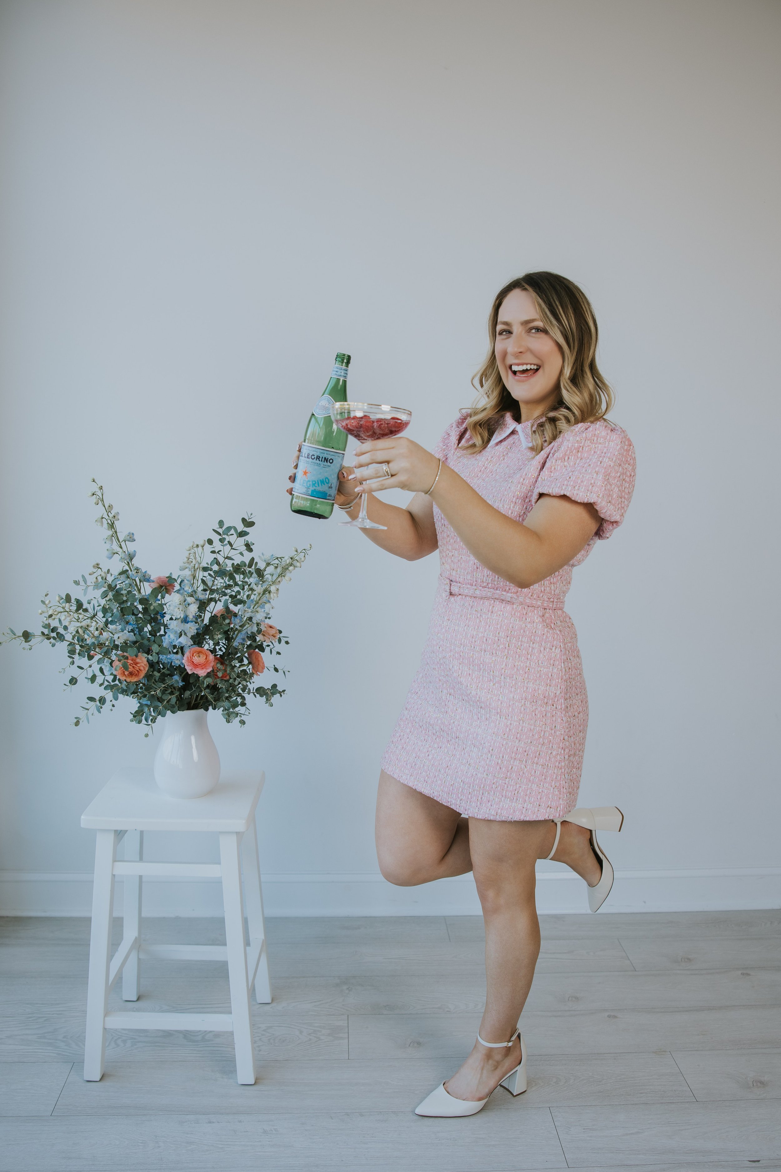 Kylie Lambert smiling and pouring a drink, celebrating her child-free life