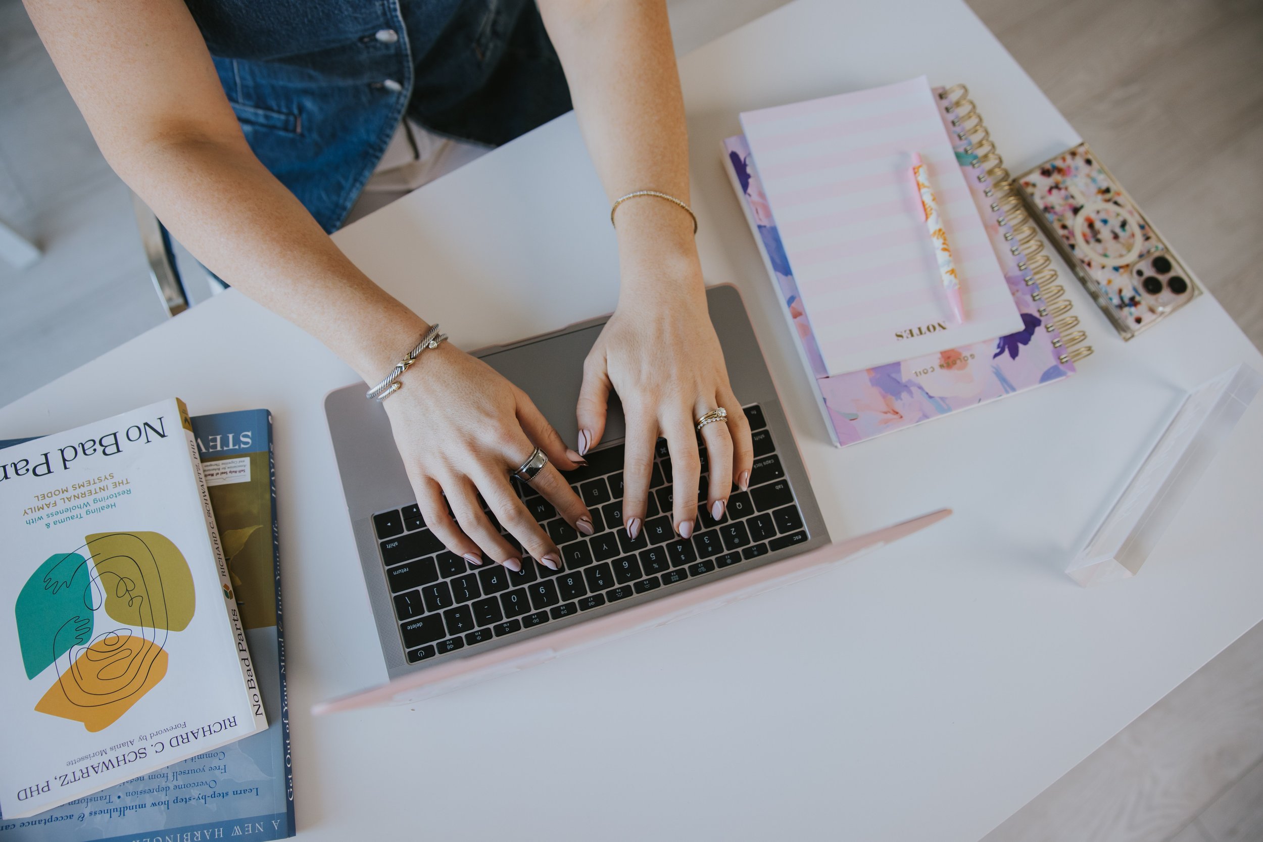 Laptop on a desk showing a sent email, a woman rereading emails after sending them