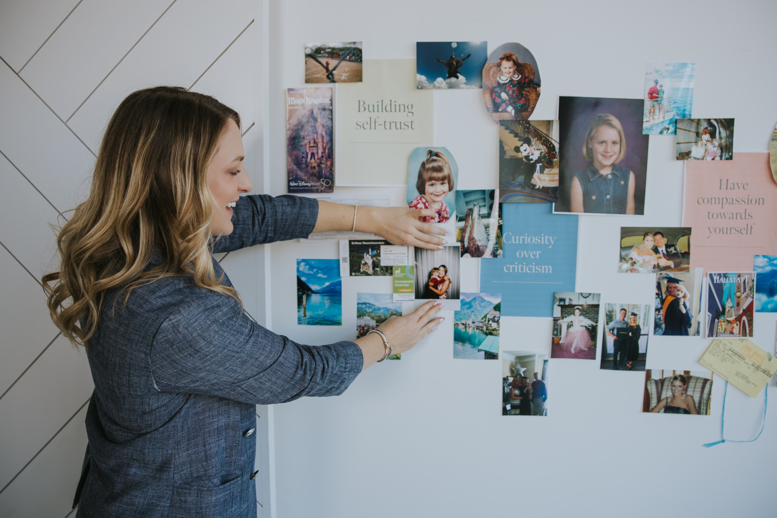 Kylie Lambert arranging a vision board with the words building self-trust and curiosity over criticism