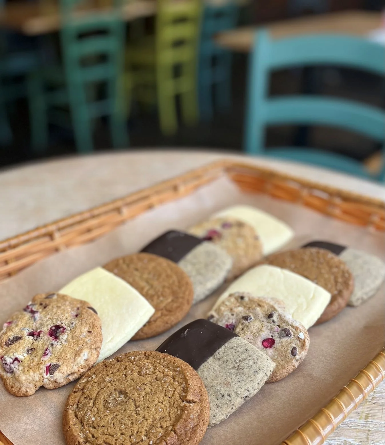 cookie assortment on parchment-lined tray on cafe table