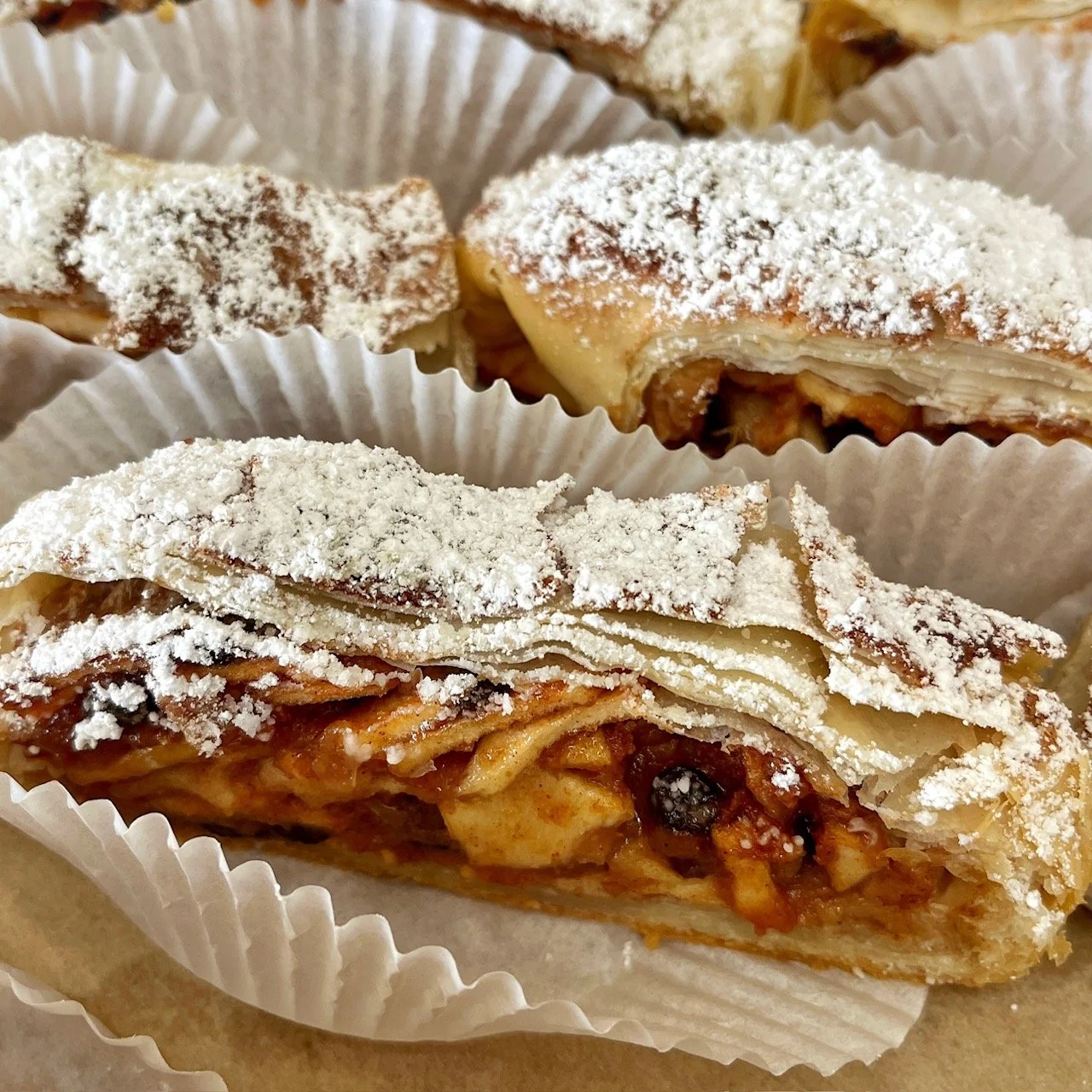 Slices of apple strudel dessert with powdered sugar