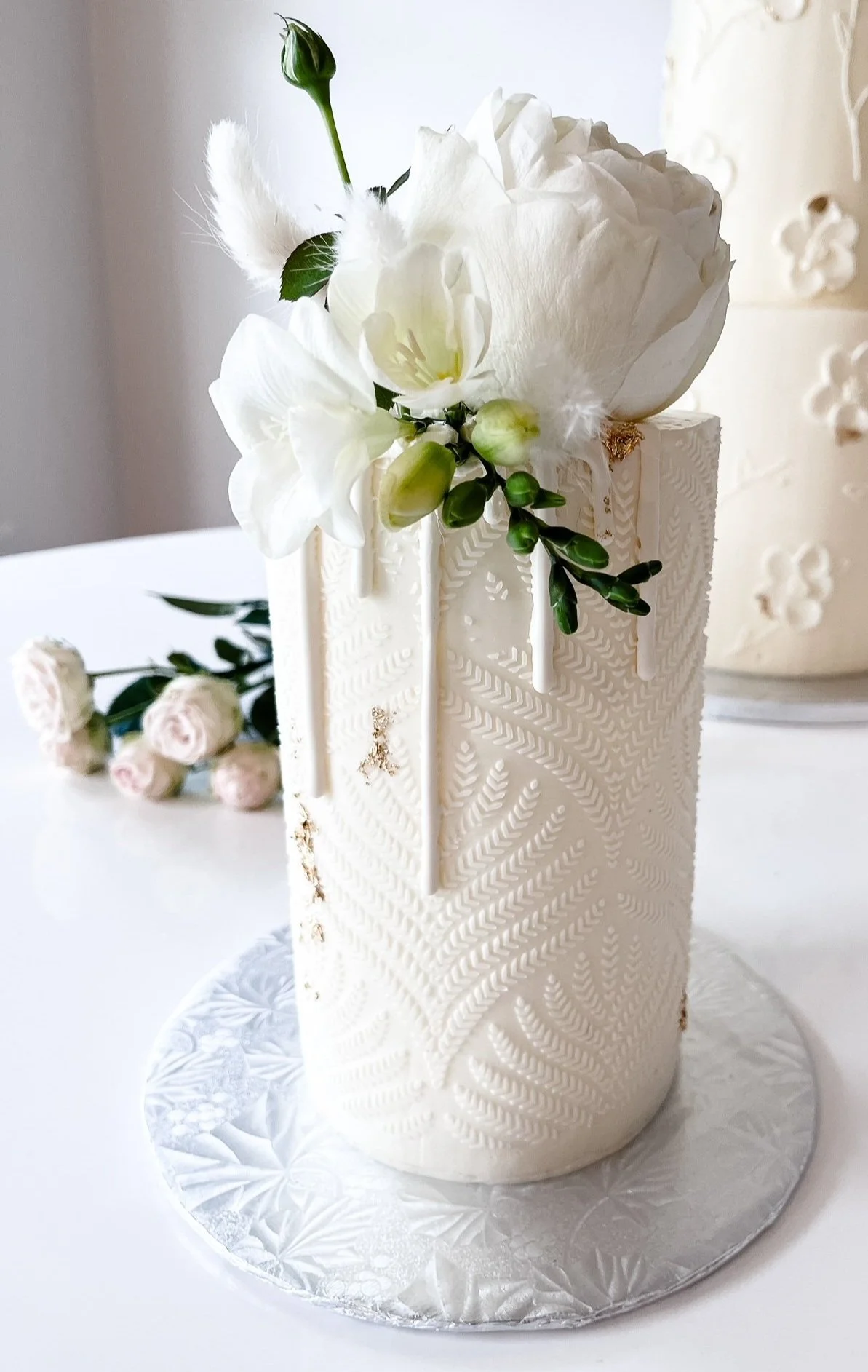single tier barrel cake with stencil and drips boho style