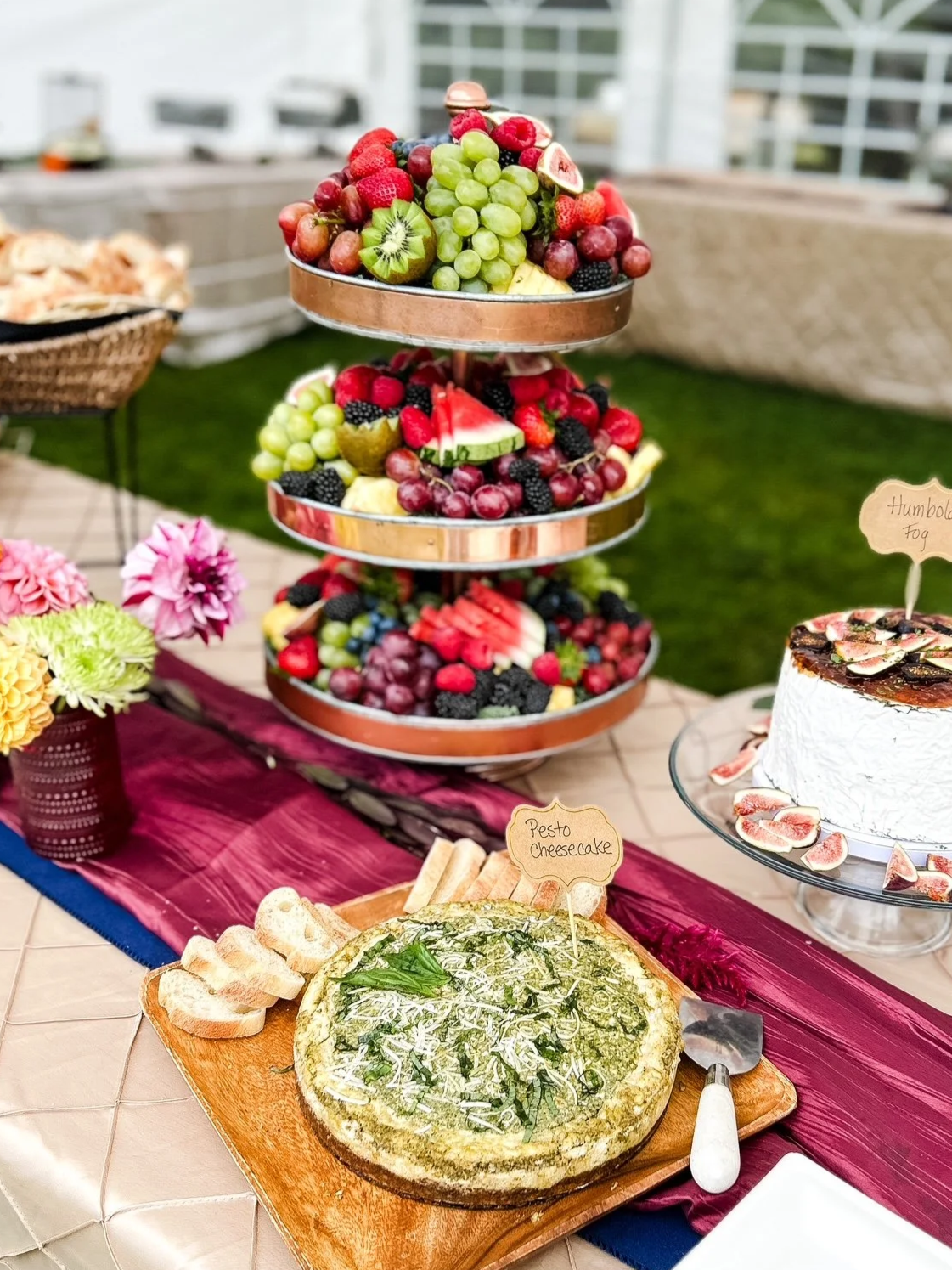 A multi-tiered tray filled with various fresh fruits