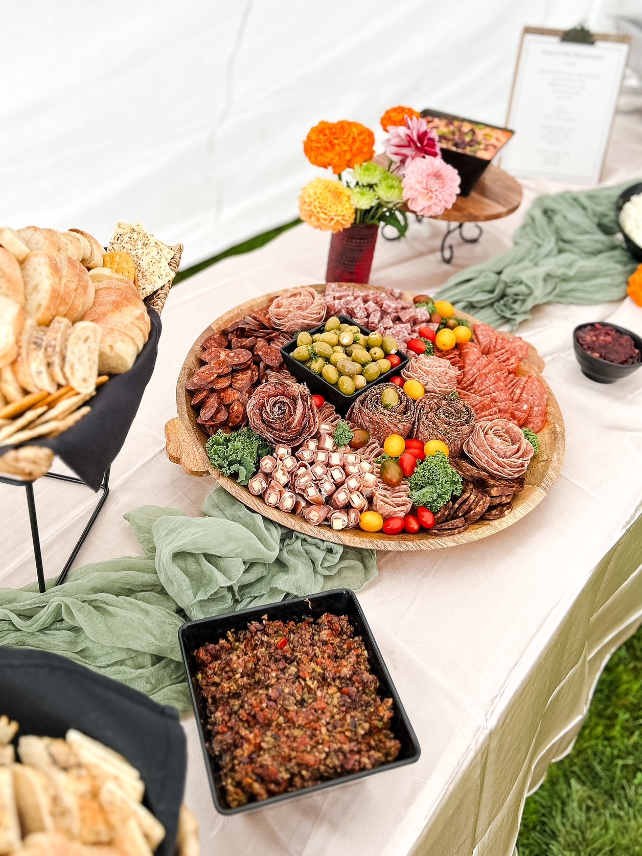 Assorted cold cuts, salami, salami roses, cheese, cherry tomatoes, and more