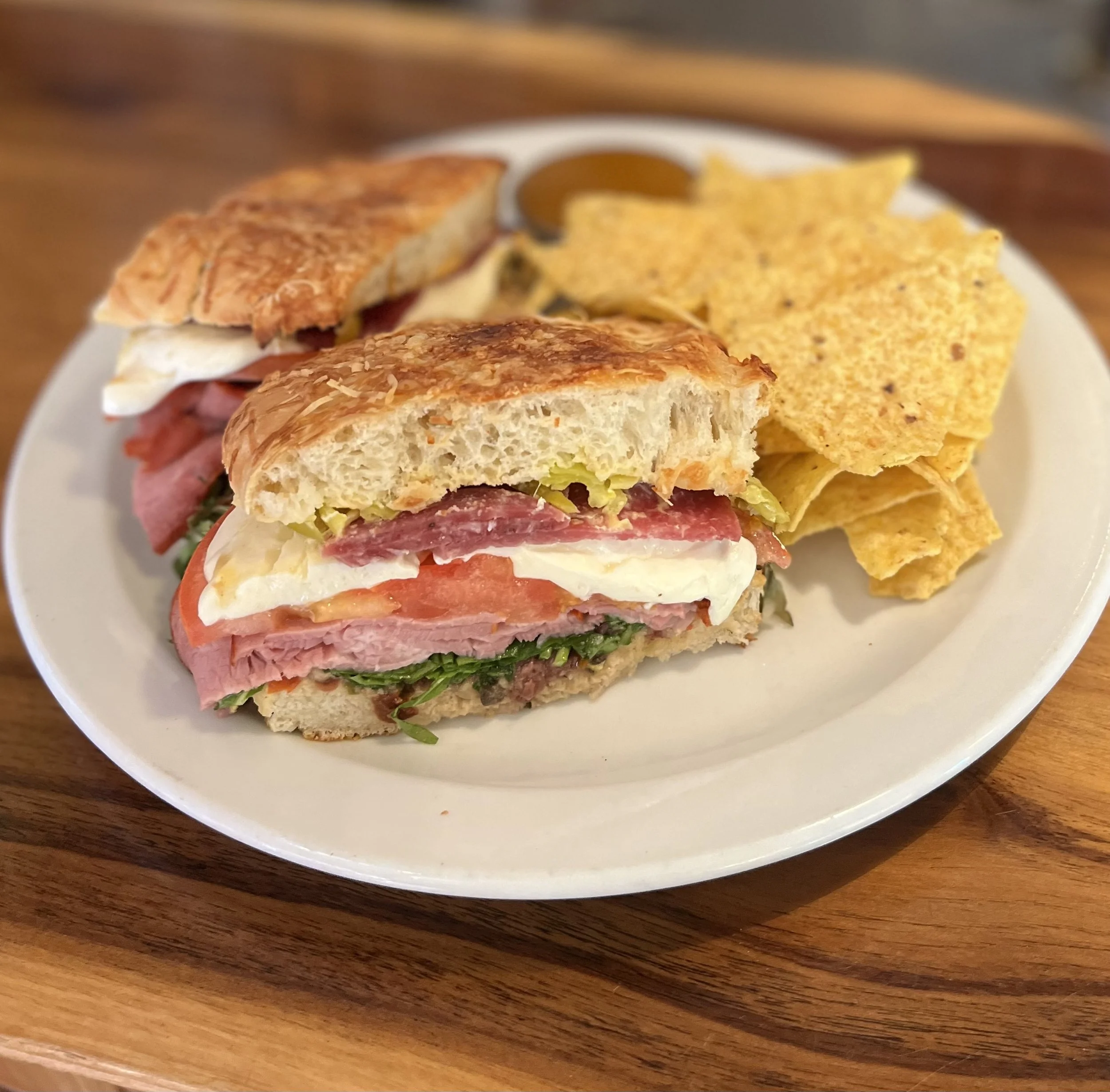 sandwhich and chips on white plate