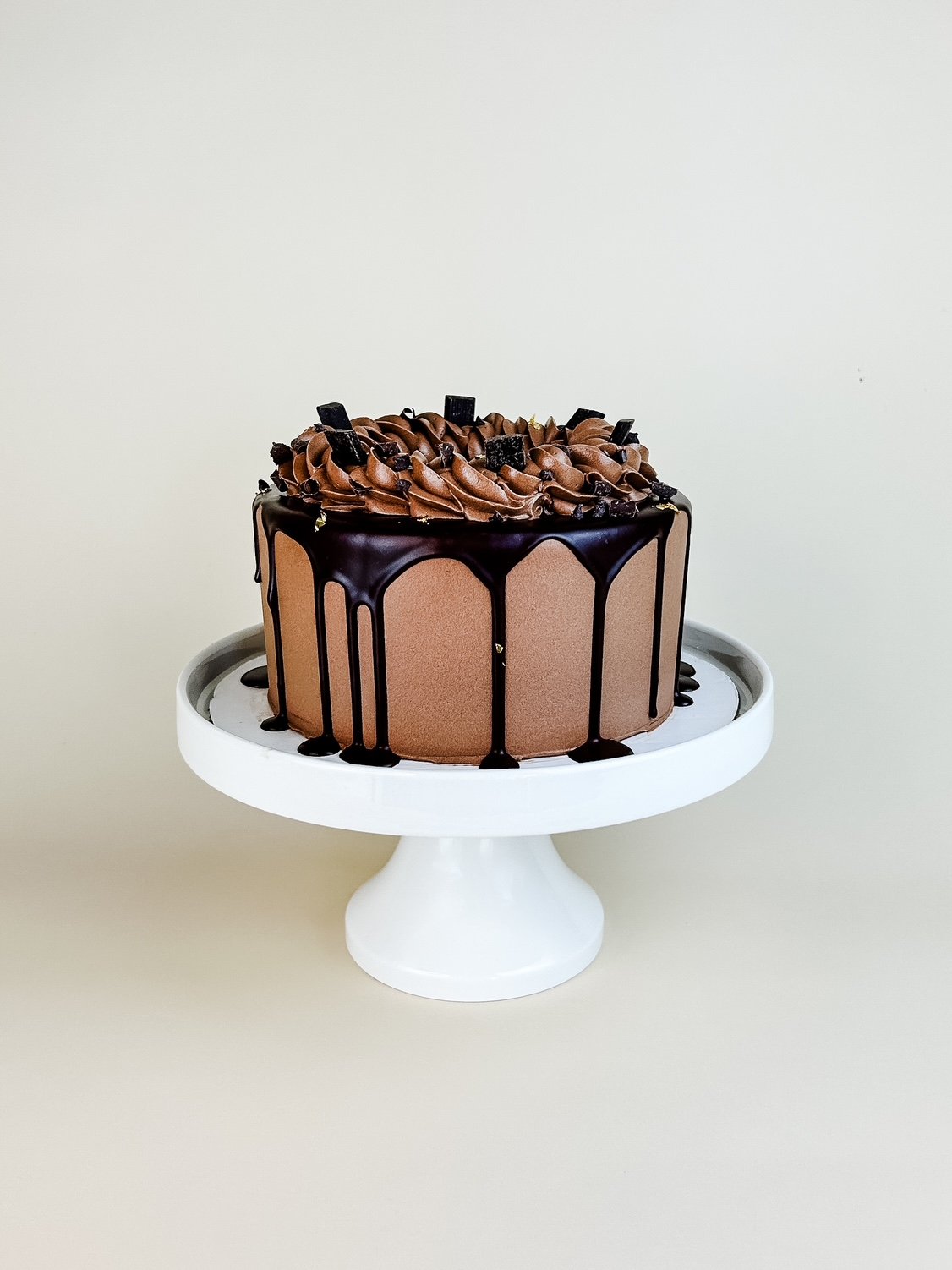 Elevated Triple Chocolate Cake on White Cake Stand