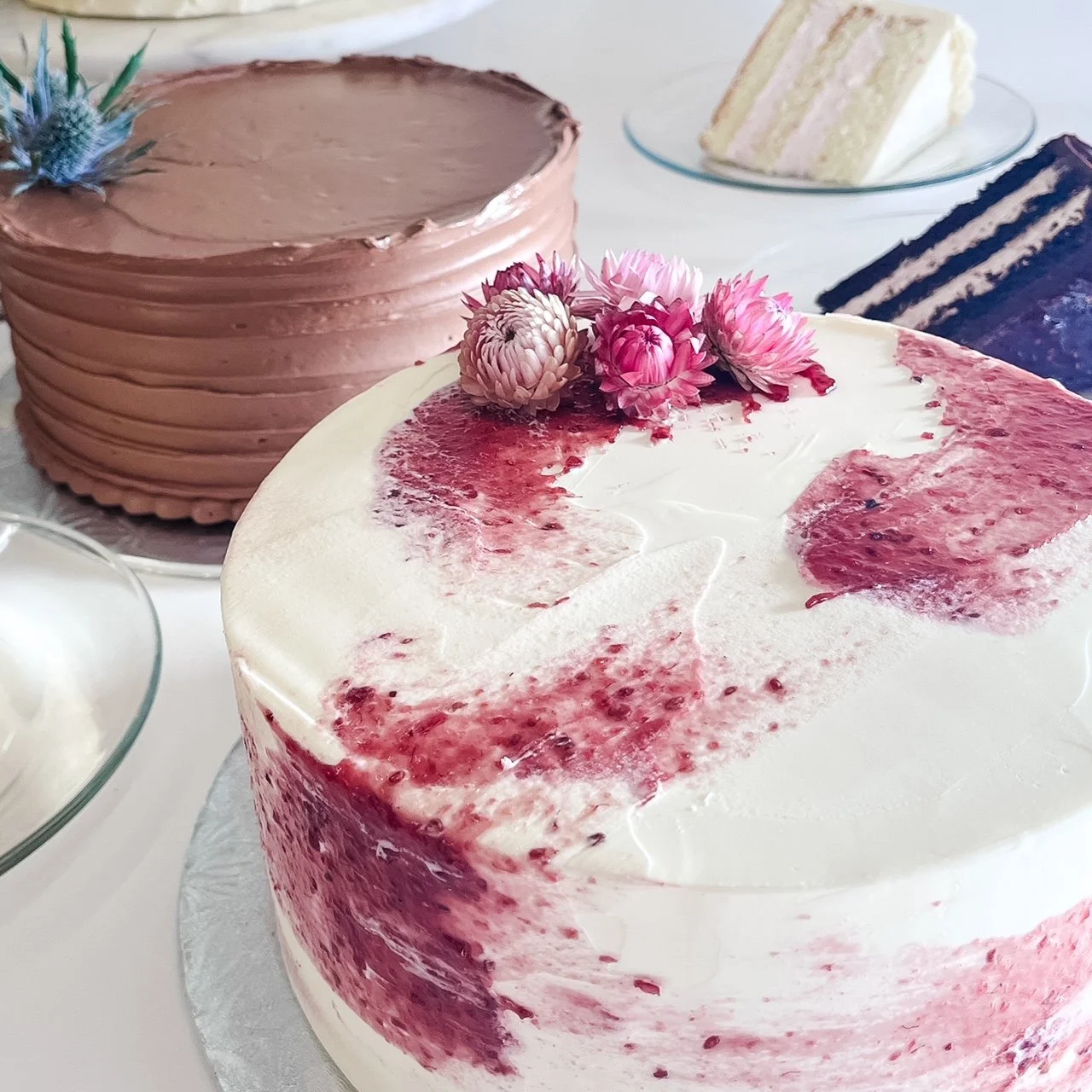 Three decorated cakes on a table