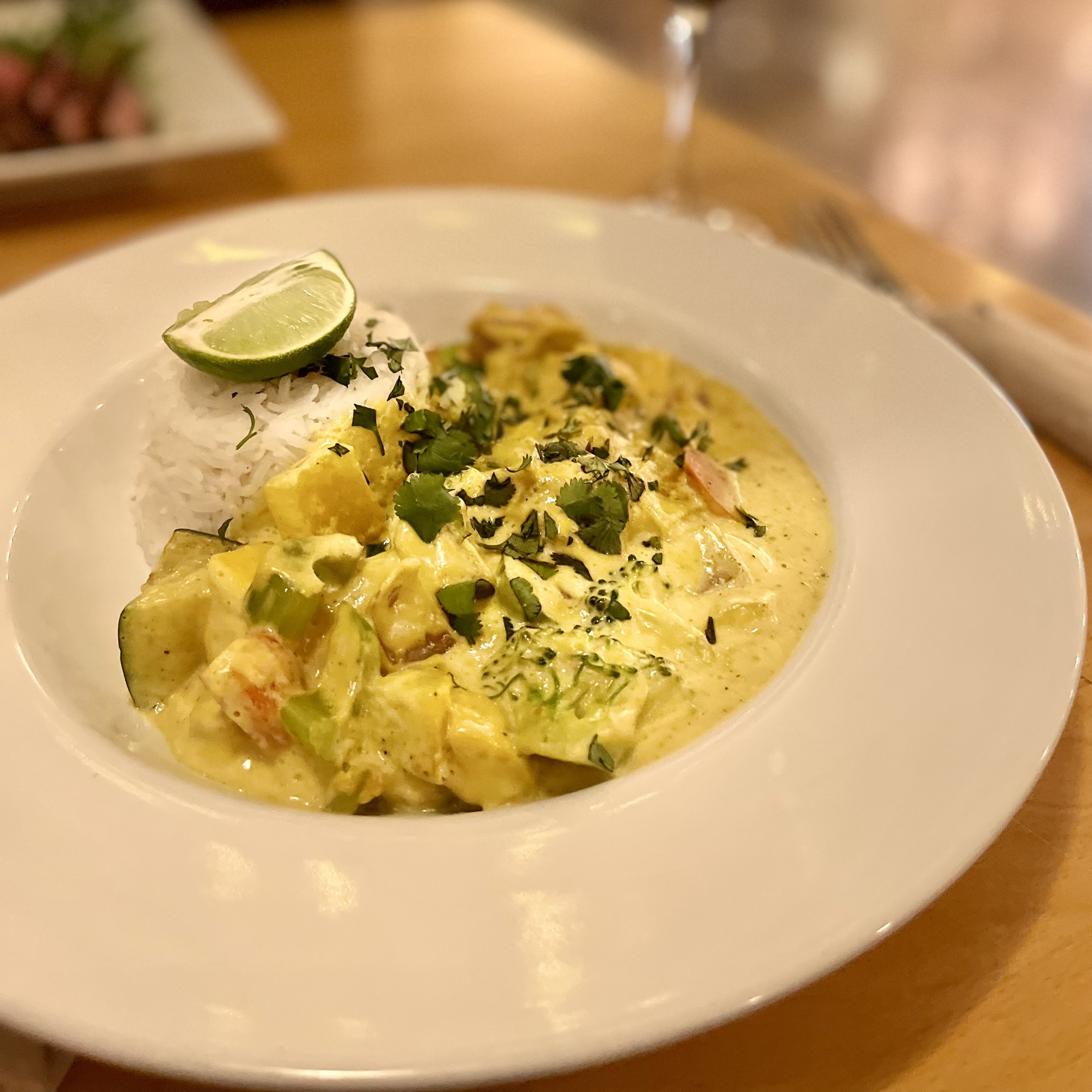 Vegetable yellow curry with rice in bowl