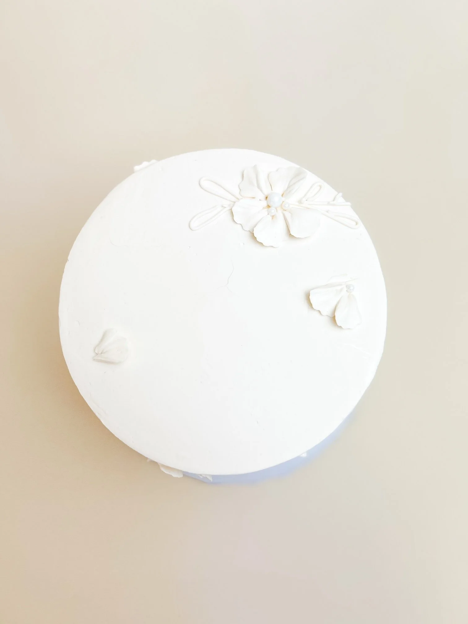 white painted floral cake from top