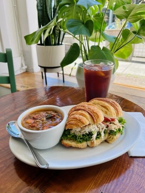 chicken salad sandwich on croissant on lentil vegetable soup