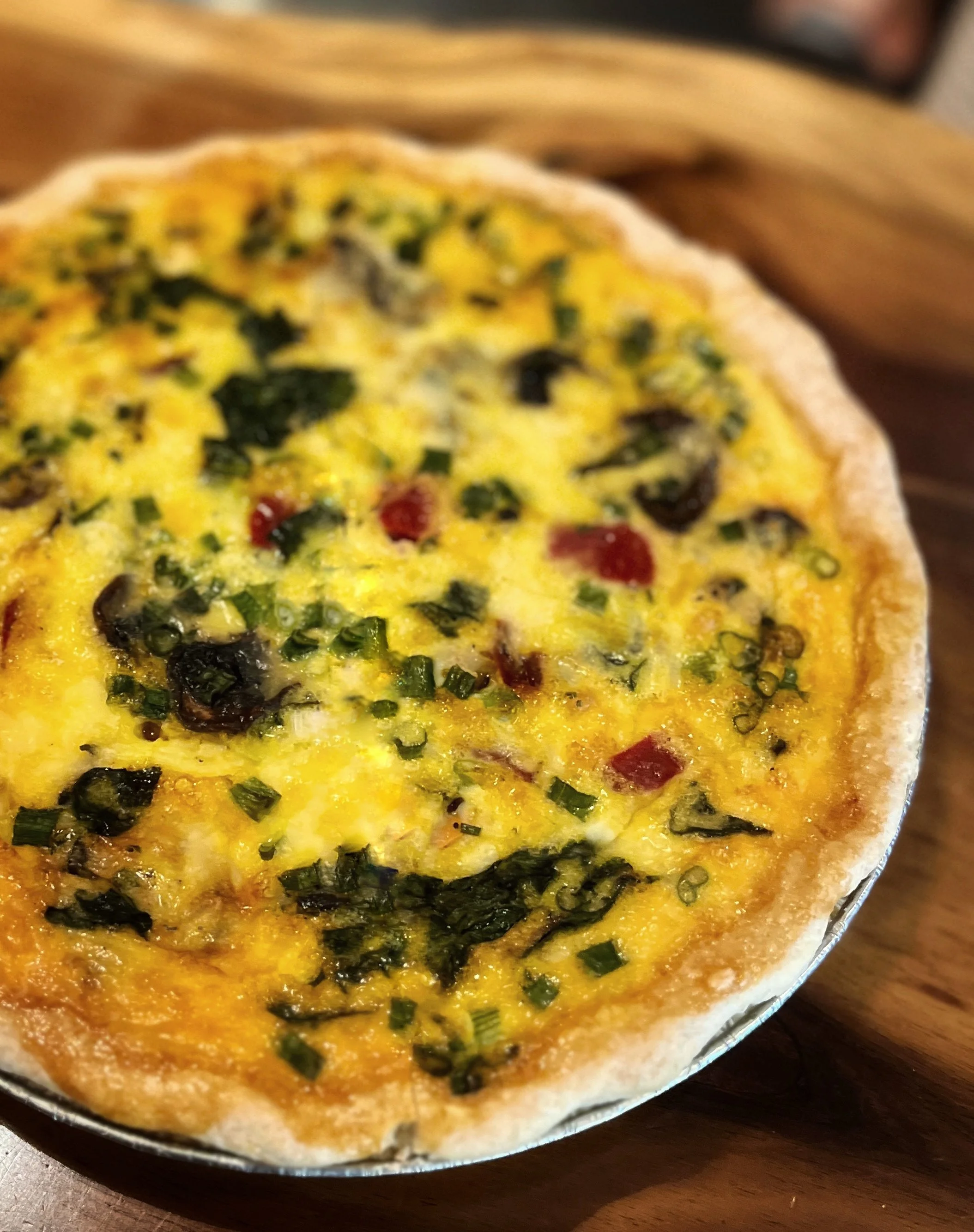vegetable quiche on wooden table