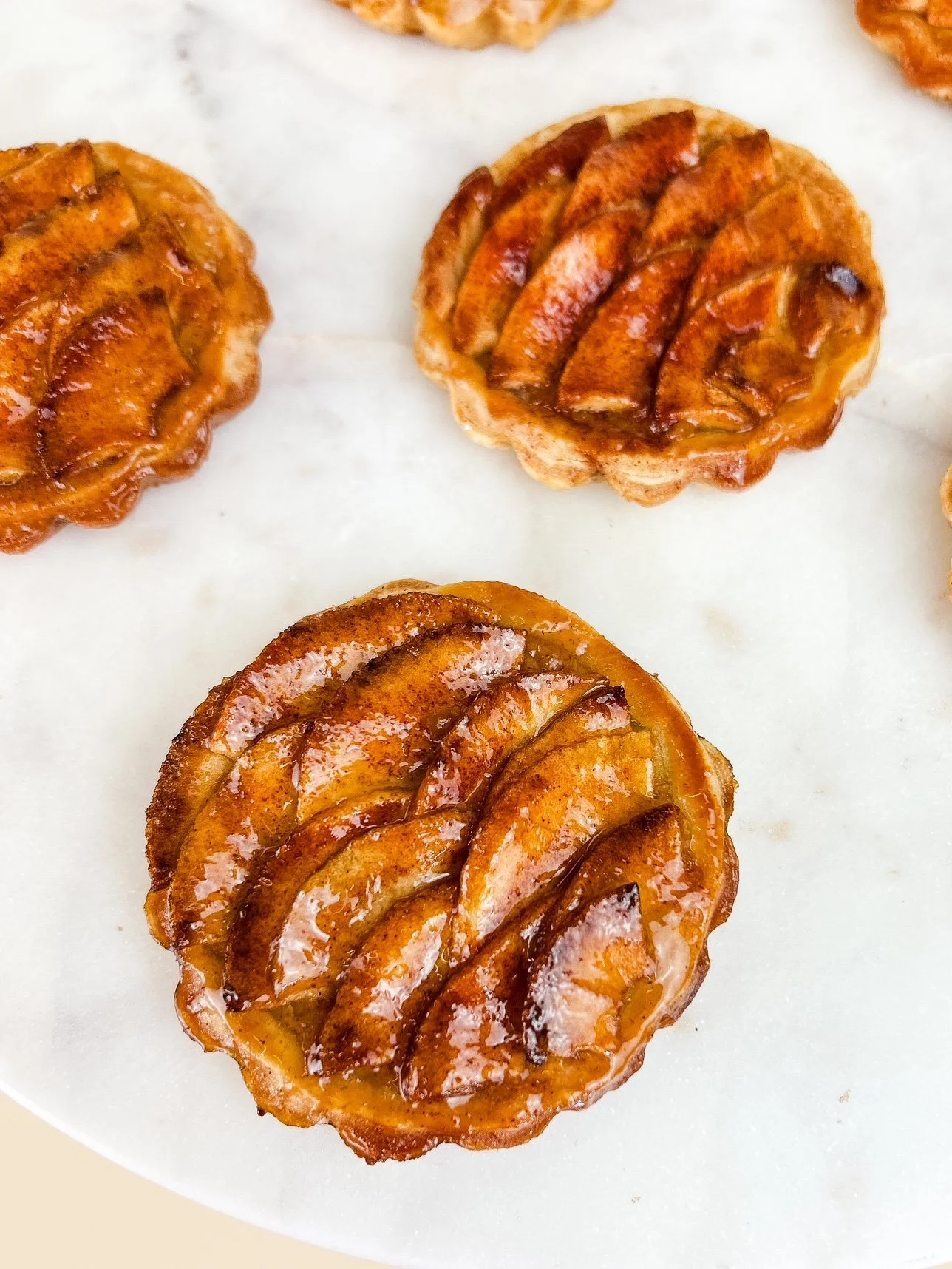 french apple tarts on marble platter