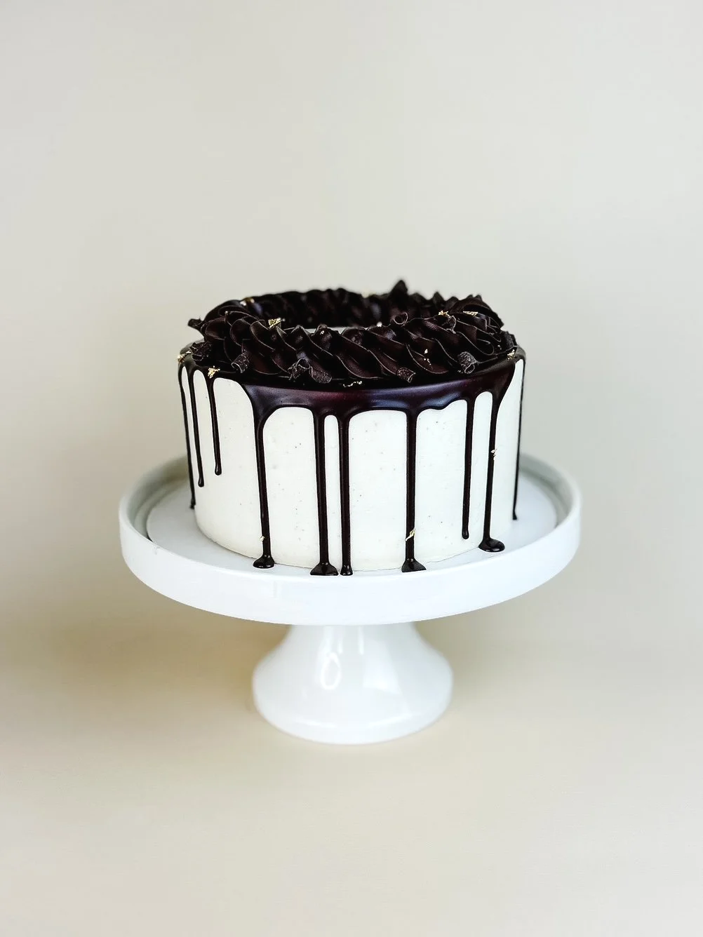 Elevated Chocolate and Vanilla Cake on White Cake Stand