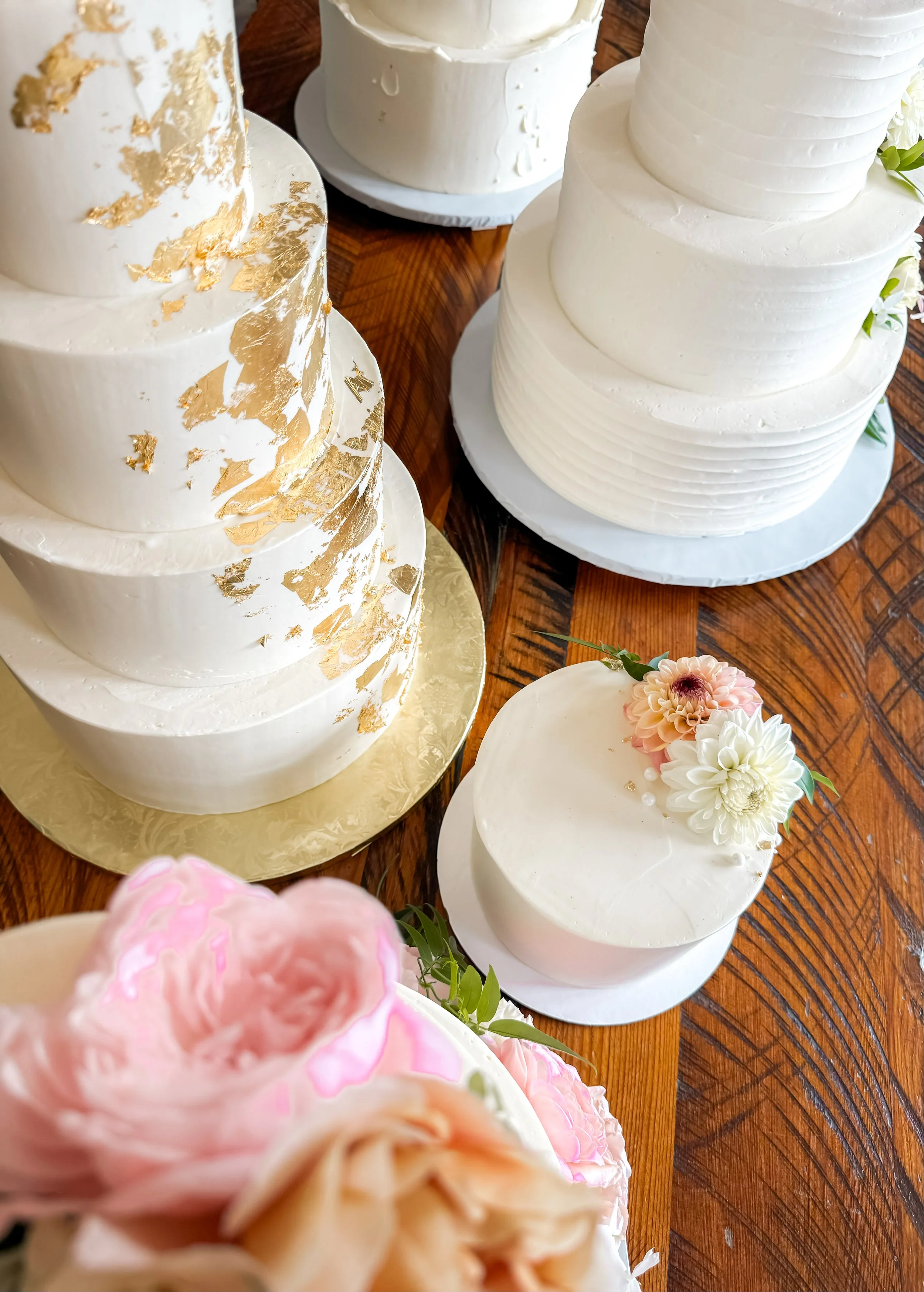 Several white tiered wedding cakes