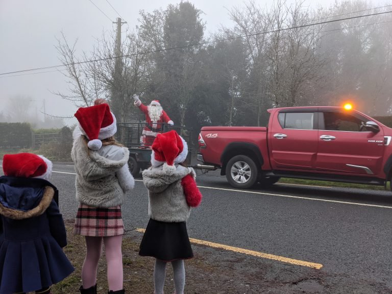 Duffy girls Waiving to Santa in Ranaghan on 6th December