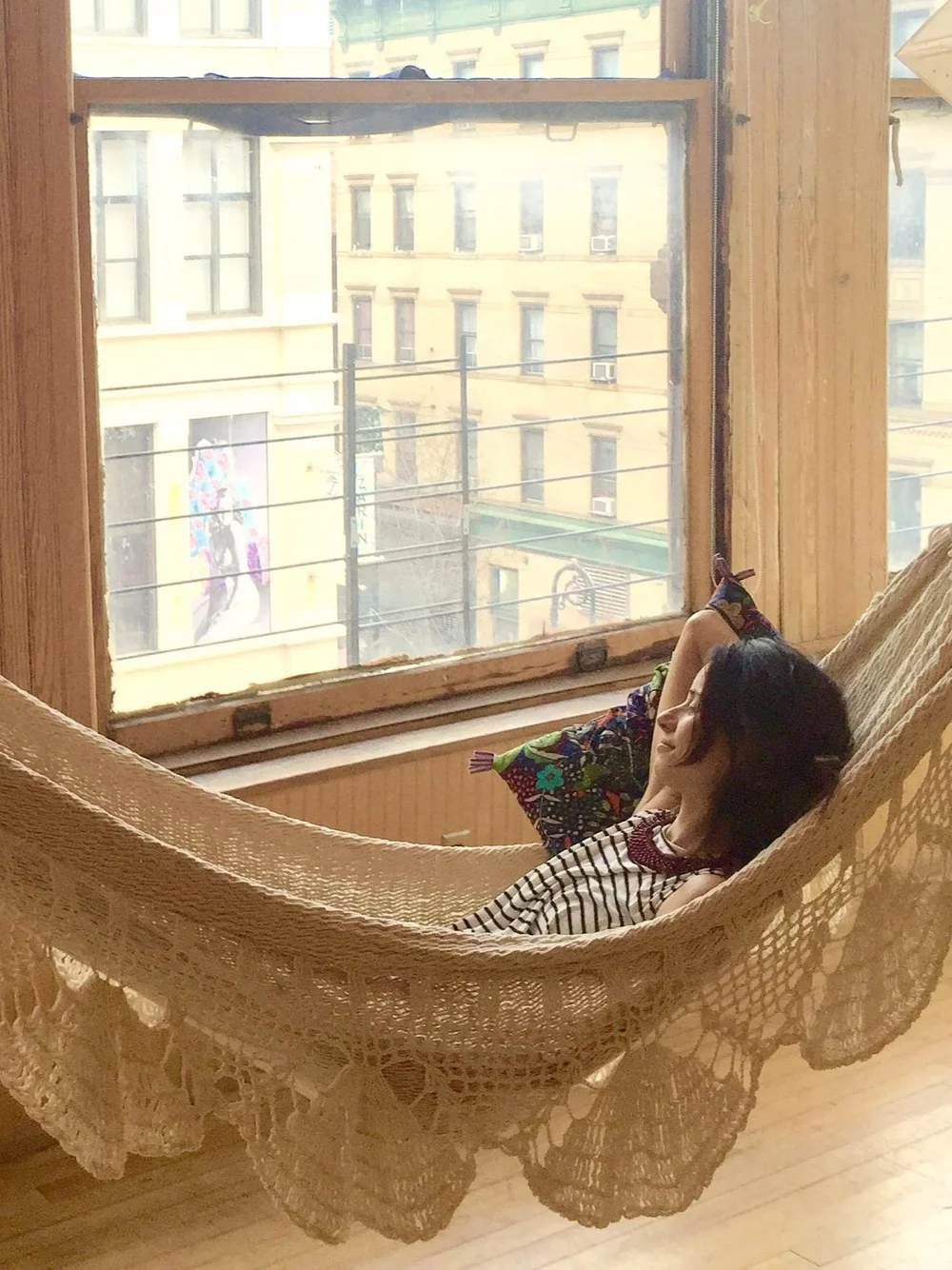 Resting in a hammock by the window