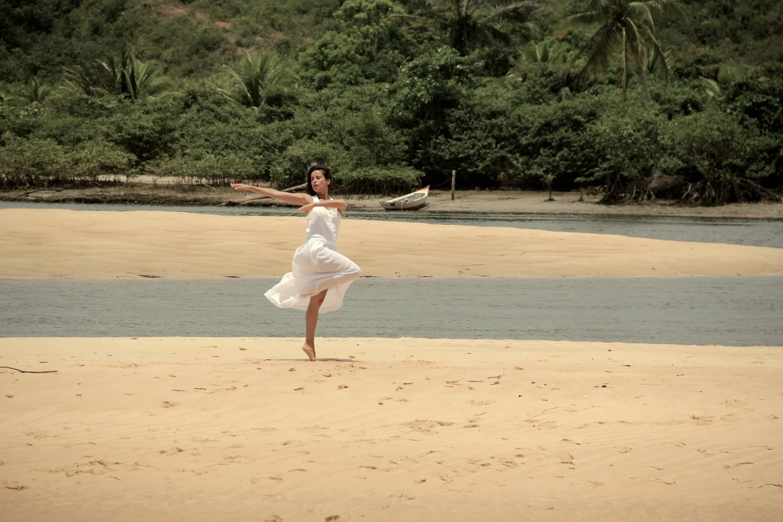 Woman dancing on the beach embracing a natural wellness lifestyle