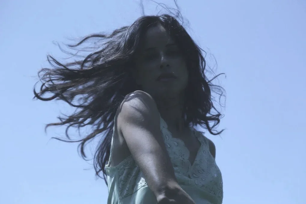 Woman with hair flowing in wind, symbol of natural vitality
