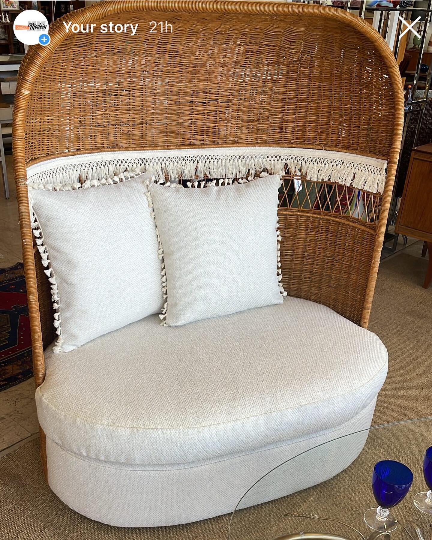 Vintage wicker and rattan dome hooded loveseat. 
(Newly reupholstered in sunbrella fabric) (48&rdquo;l. X 58&rdquo;ht. X 32&rdquo;d.)