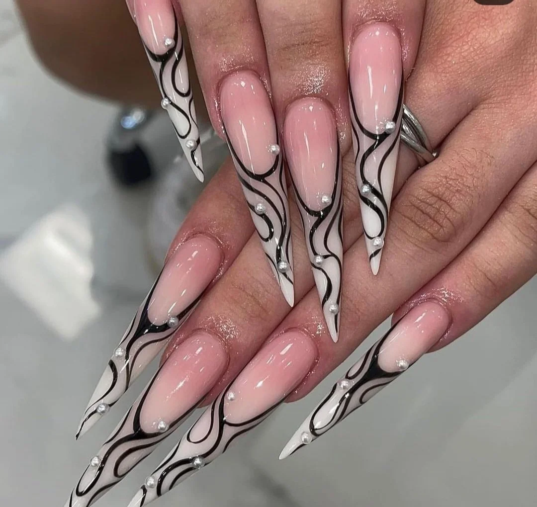 Stiletto nails with nail black and white nail art