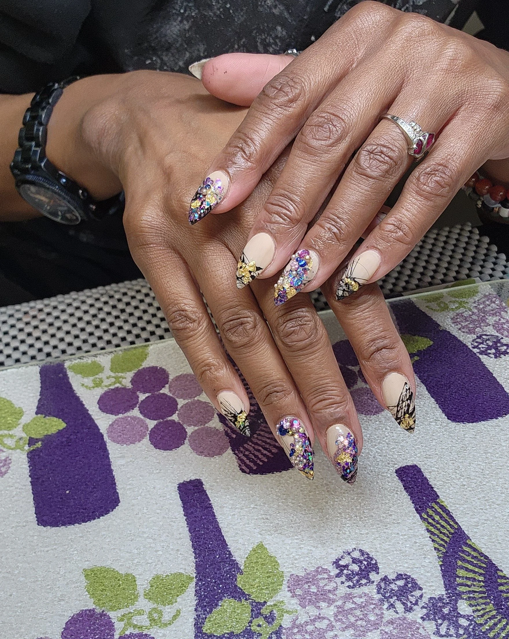 Stiletto nails with free-hand nail art and gems