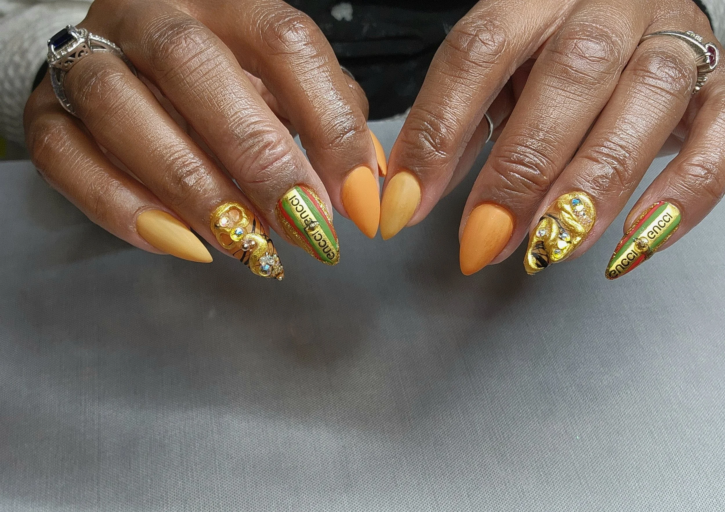 orange stiletto nails with nail art