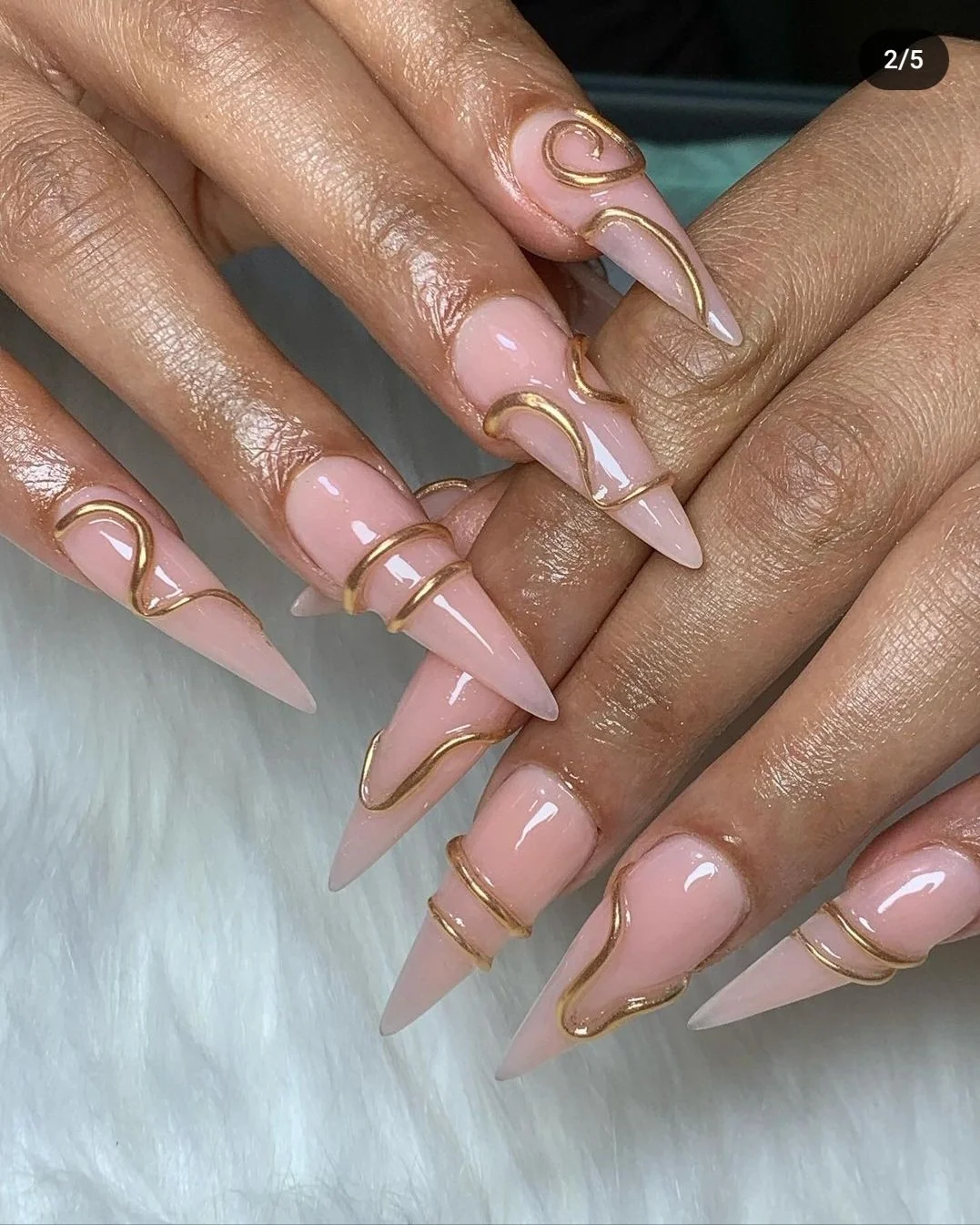 stiletto nails with gold nail art