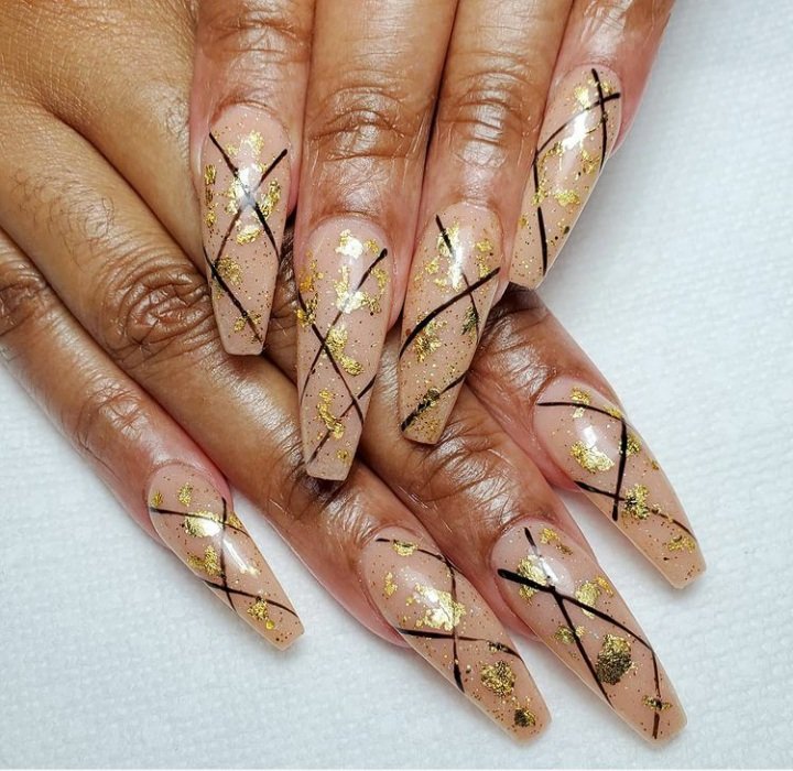 Ballerina nails with gold and black nail art