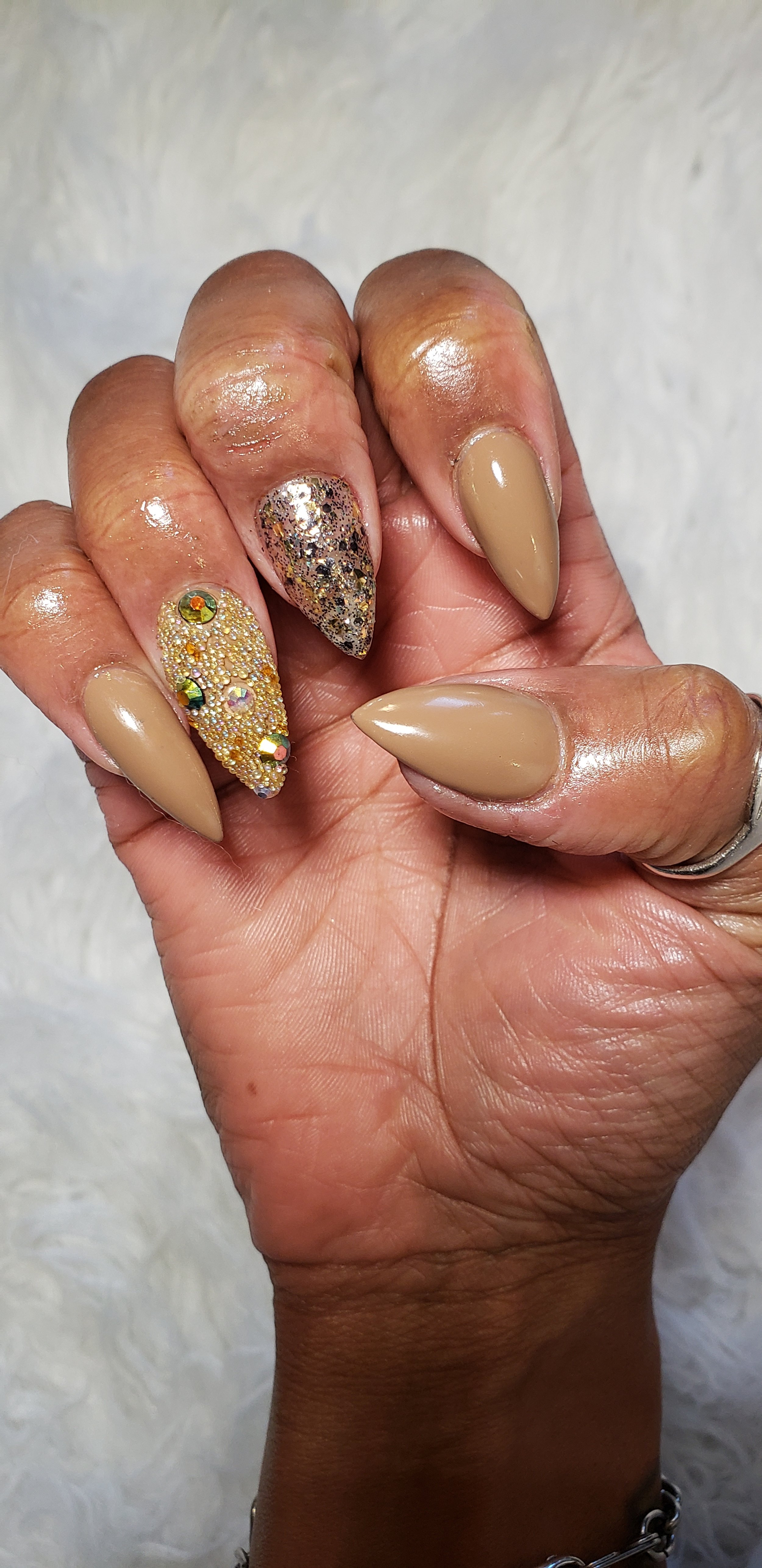 tan stiletto nails with nair art