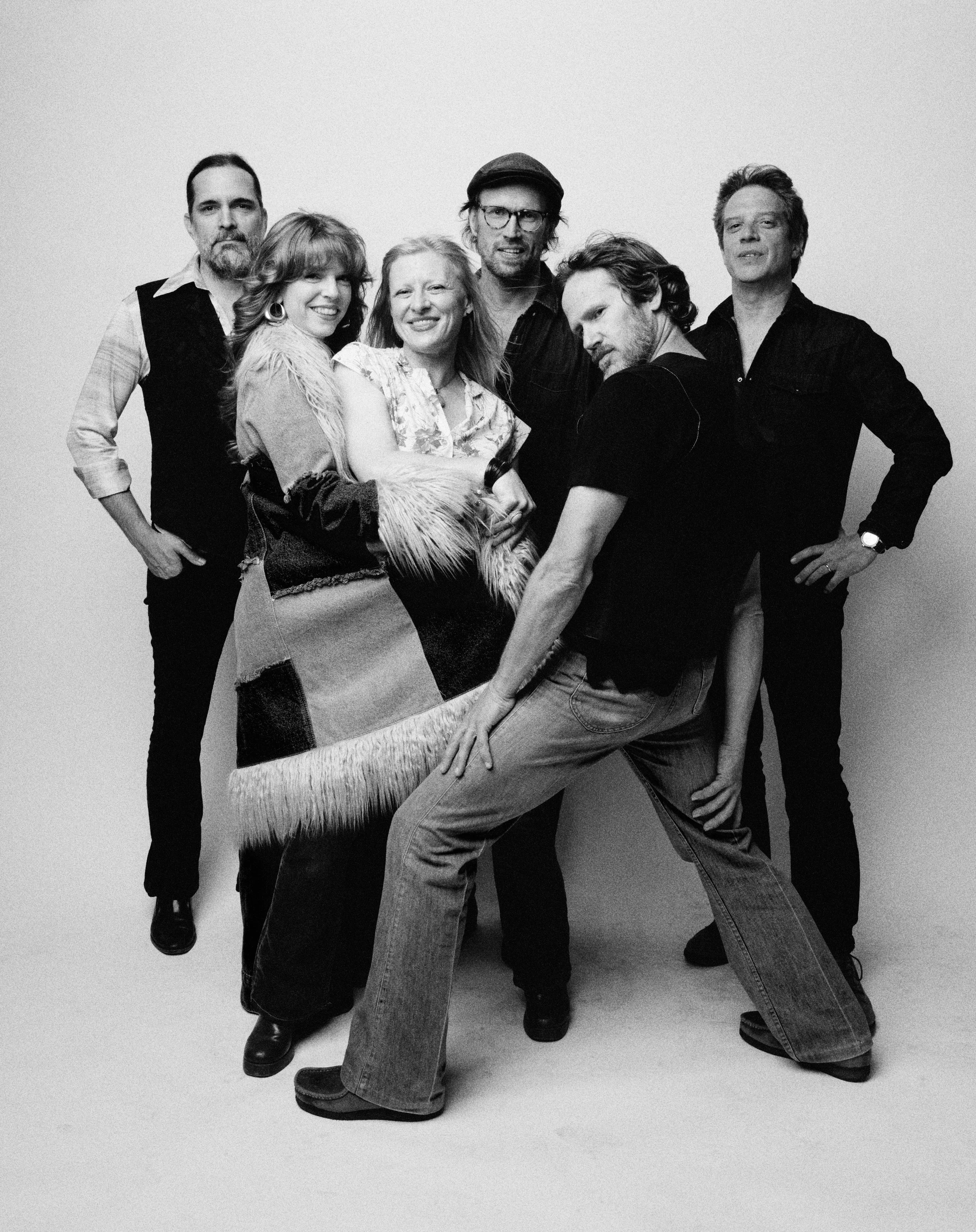 Mike Holtz, Melissa Brausch-Wilford, Lindsay Weinberg, Dan Ingenthron, Josh Chicoine, and Mike Vanier of Fleetwood Mac tribute band Second Hand News pose together in a black and white band portrait, photographed by Chris Strong