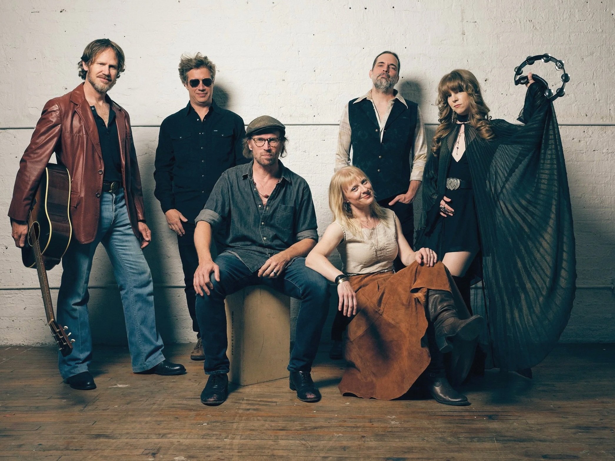Josh Chicoine, Mike Vanier, Dan Ingenthron, Lindsay Weinberg, Mike Holtz, and Melissa Brausch-Wilford of Fleetwood Mac tribute band Second Hand News pose with guitar, tambourine, and cape in a cool loft in Chicago. Photo by Chris Strong.