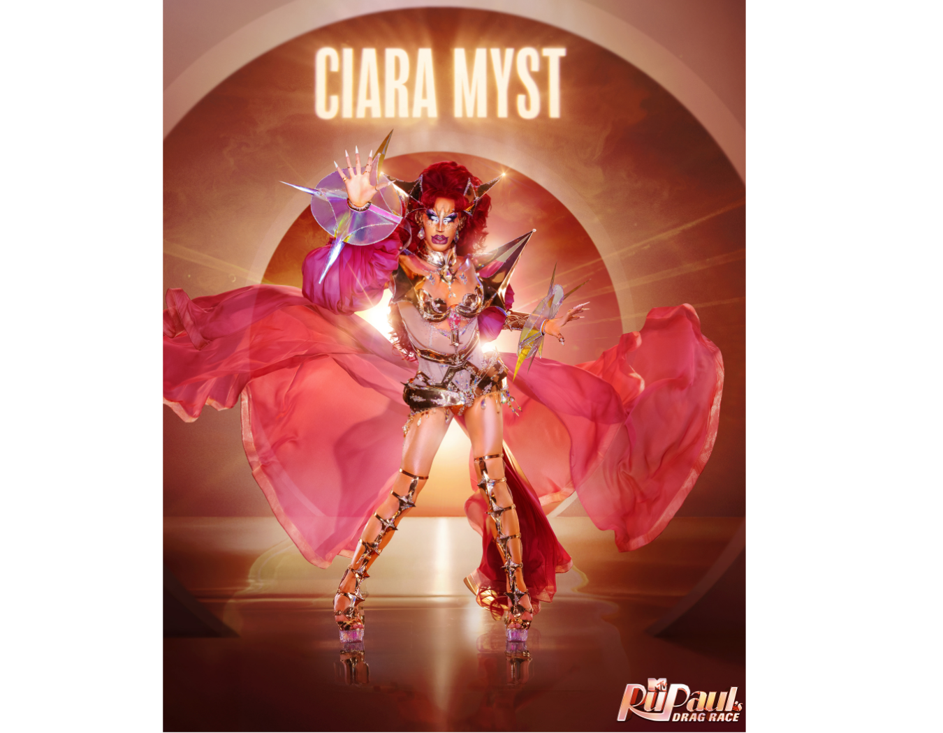 A drag queen performer ( Ciara Myst) in a bright, elaborate costume with metallic and pink accents, surrounded by colorful lights and lens flares, striking a confident pose with arms extended.