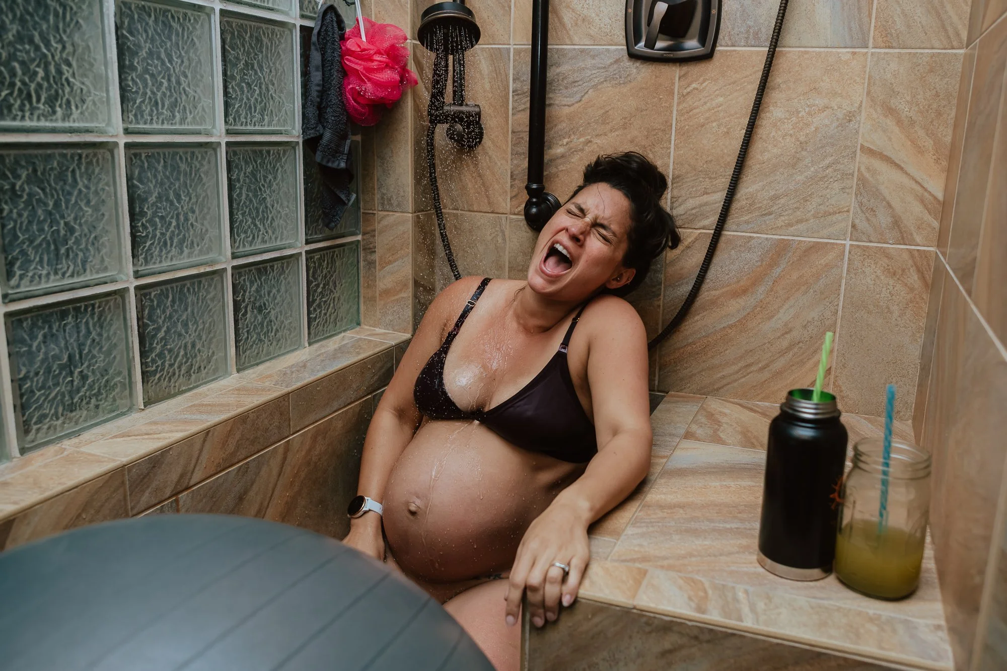 mom-labors-in-showing-roaring-a-scream-through-contraction-as-water-from-shower-head-flows-home-birth-photographer-san-antonio-texas