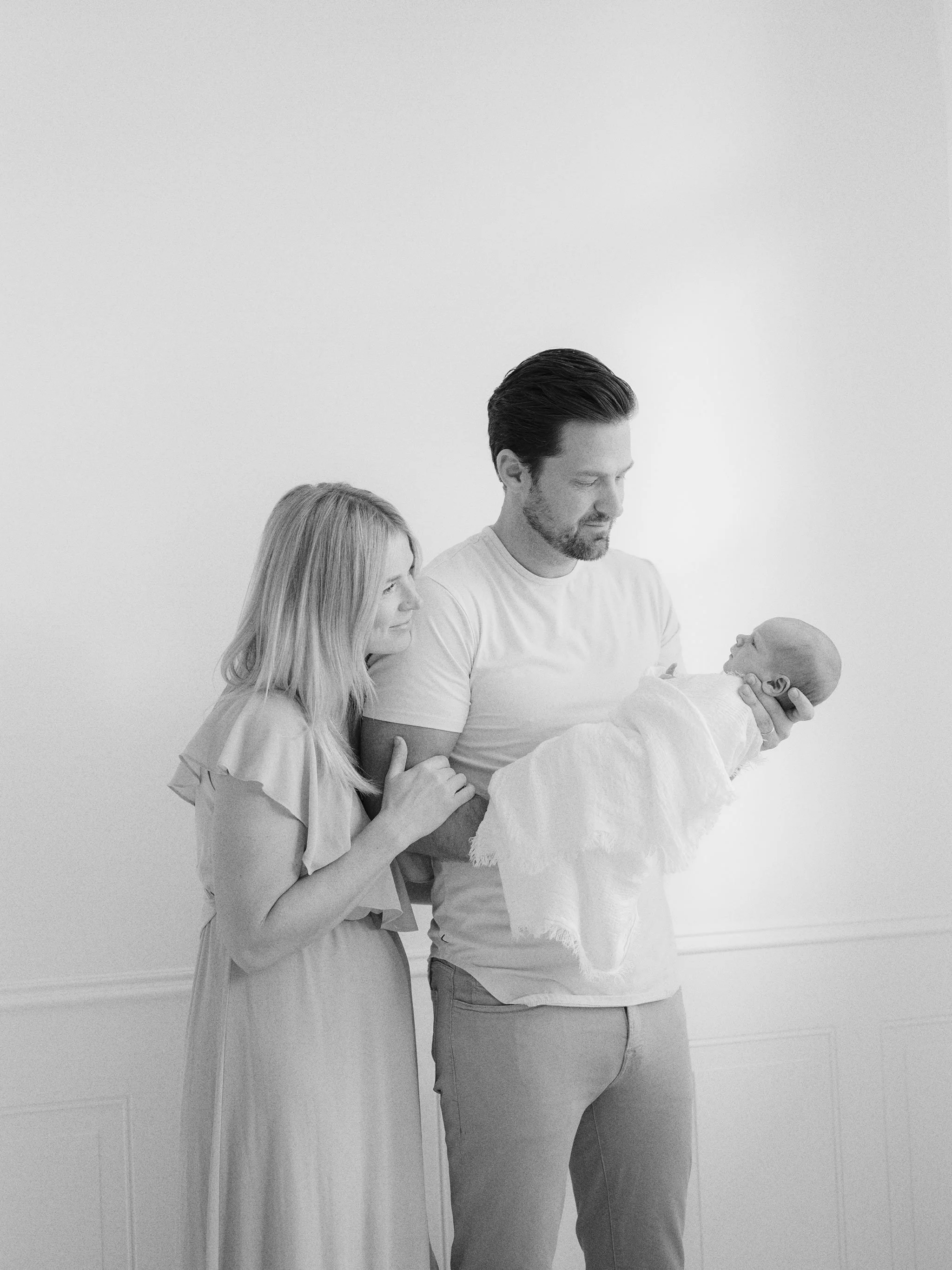 family looking lovingly at newborn