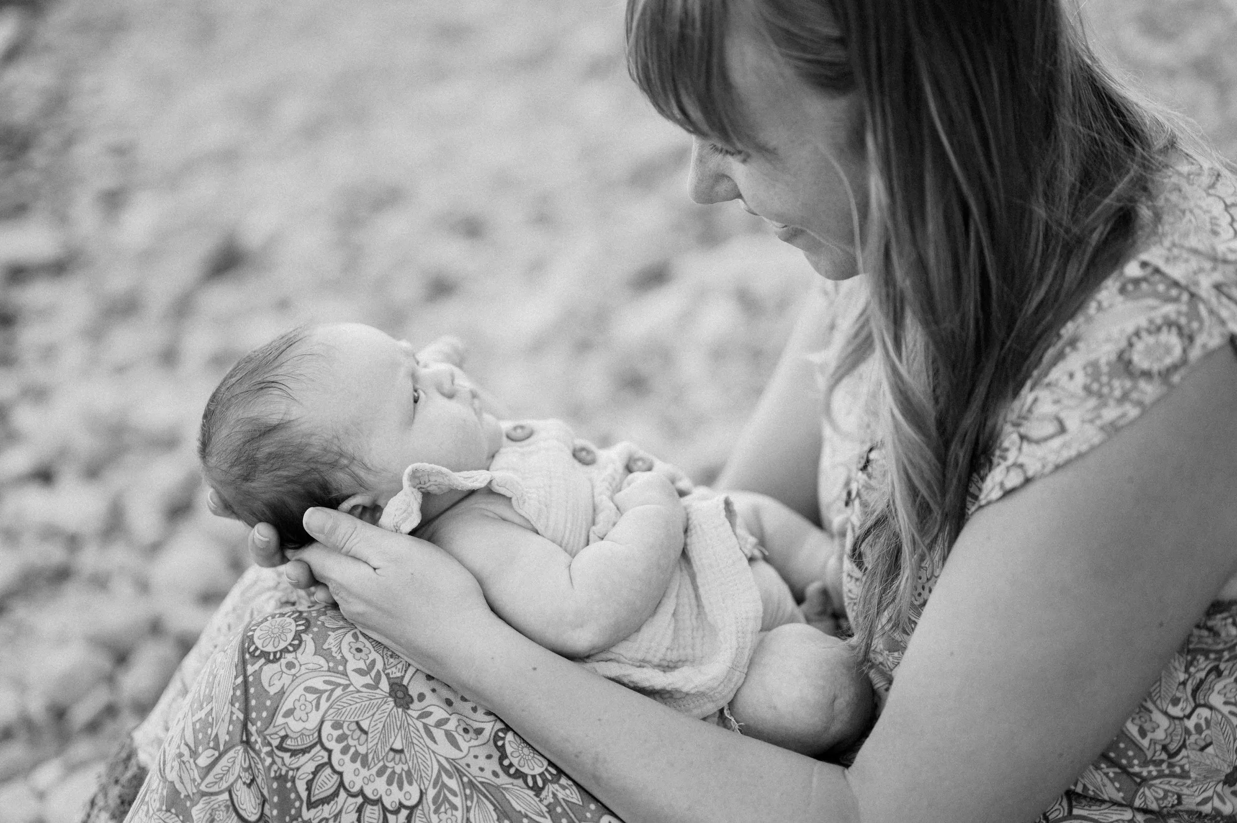 Black and white photo of a woman holding a baby