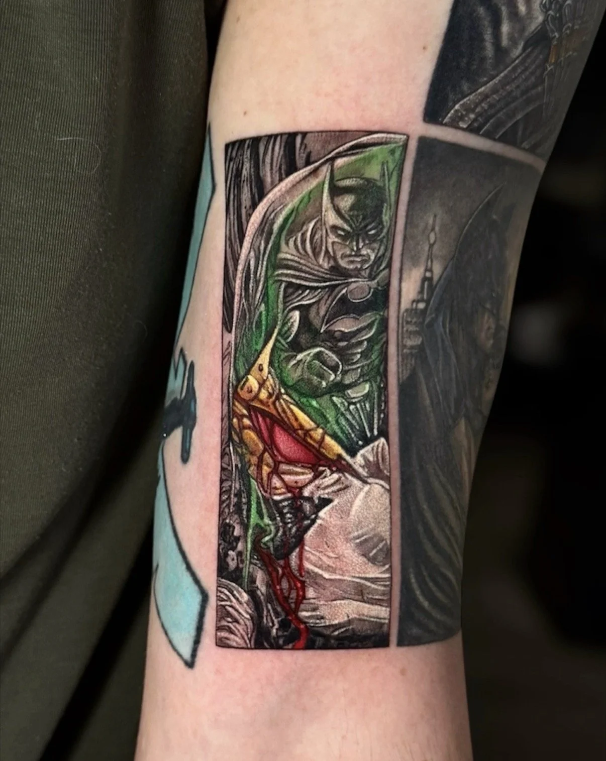 Colour Batman and Joker comic panel tattoo with green and red accents, by Chris Kennedy.