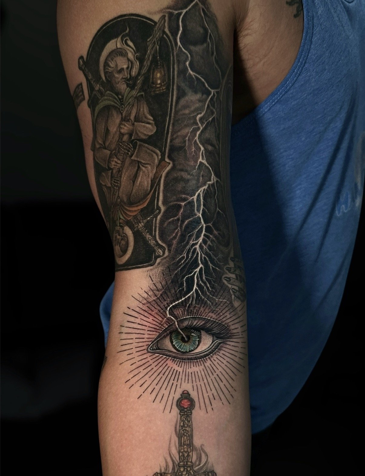 Black and grey fantasy sleeve with a lantern-bearing figure, lightning and an eye, by Chris Kennedy.